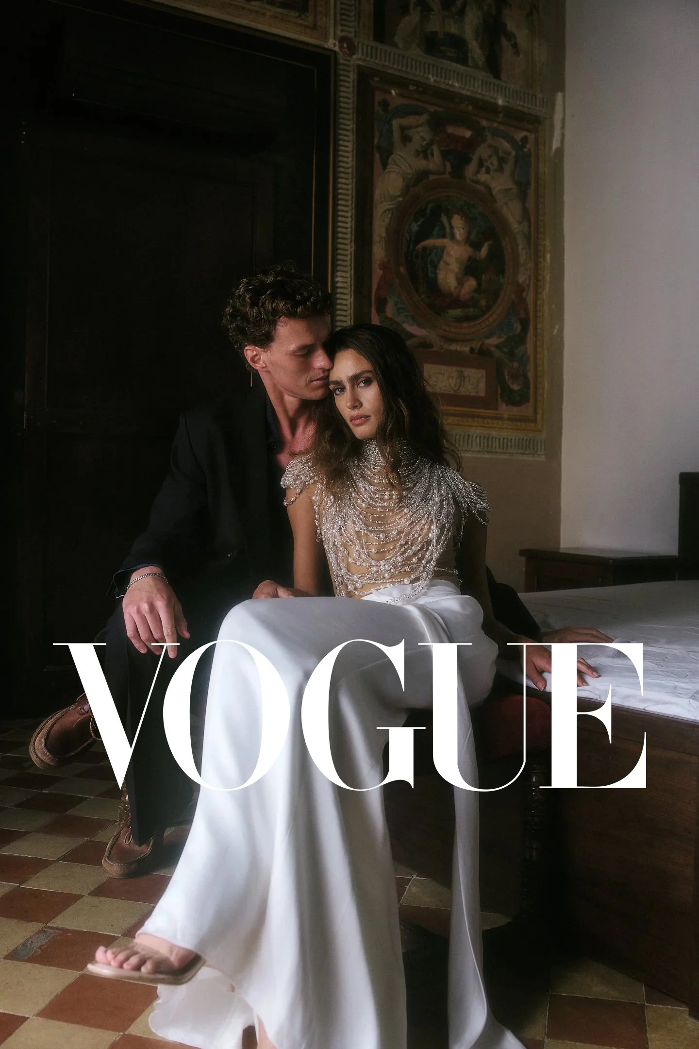 Elena and Oscar on an antique bed in a historic townhouse near Barcelona – Vogue feature by destination wedding photographer Nieke Ross.