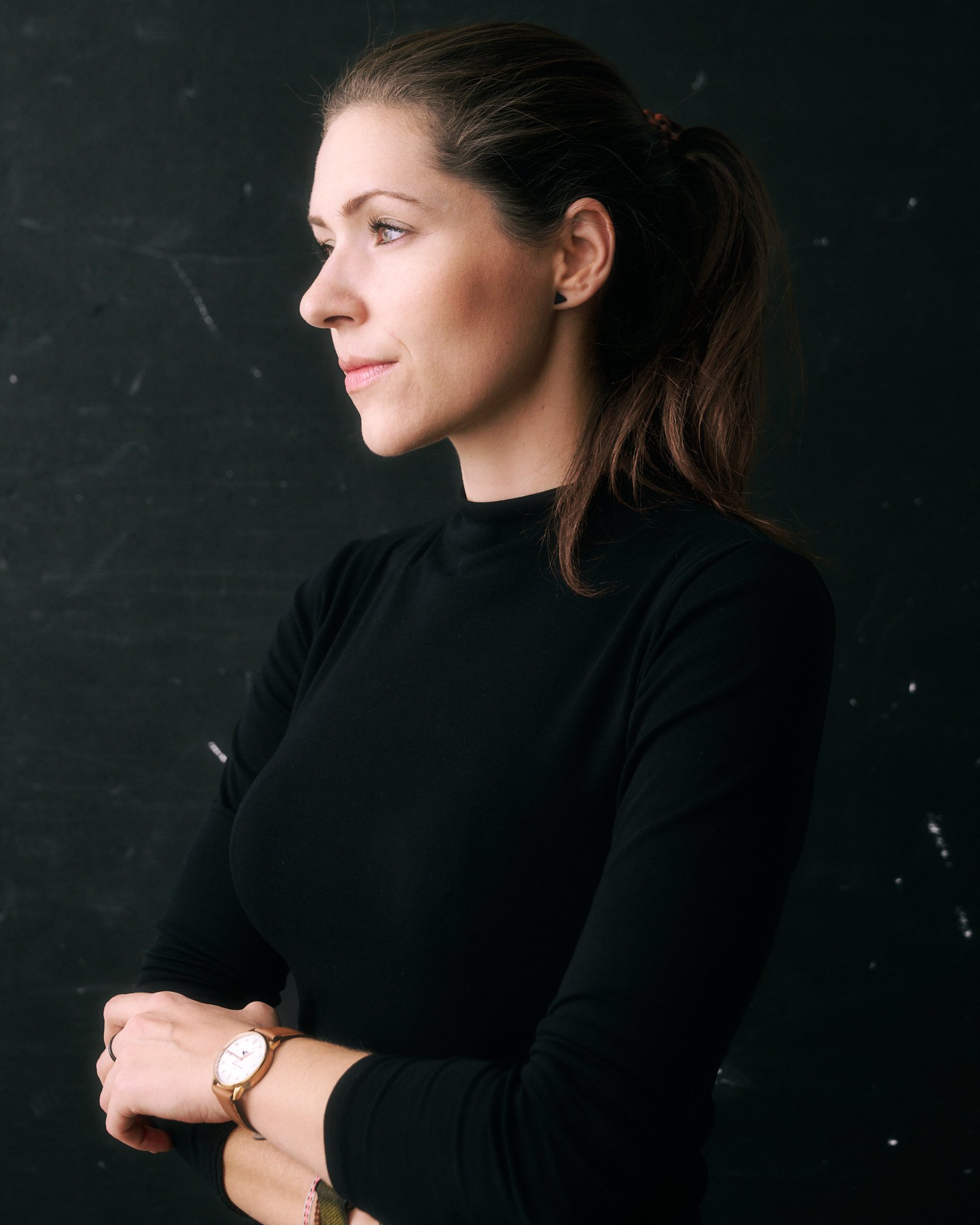 Portrait der Fotografin hinter Nieke Ross vor dunklem Hintergrund.