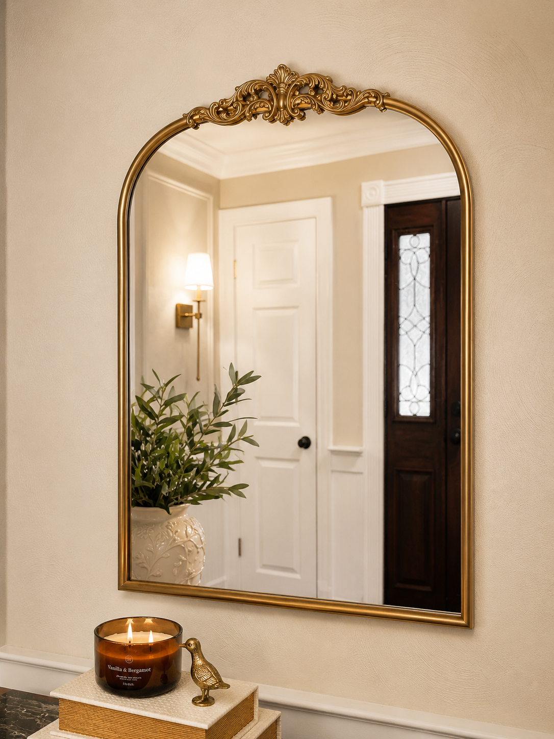 Baroque Mirror in Antique Gold,
The traditional shape and aged gold finish bring character to the entryway while reflecting light and making the space feel larger.
Shop the mirror →