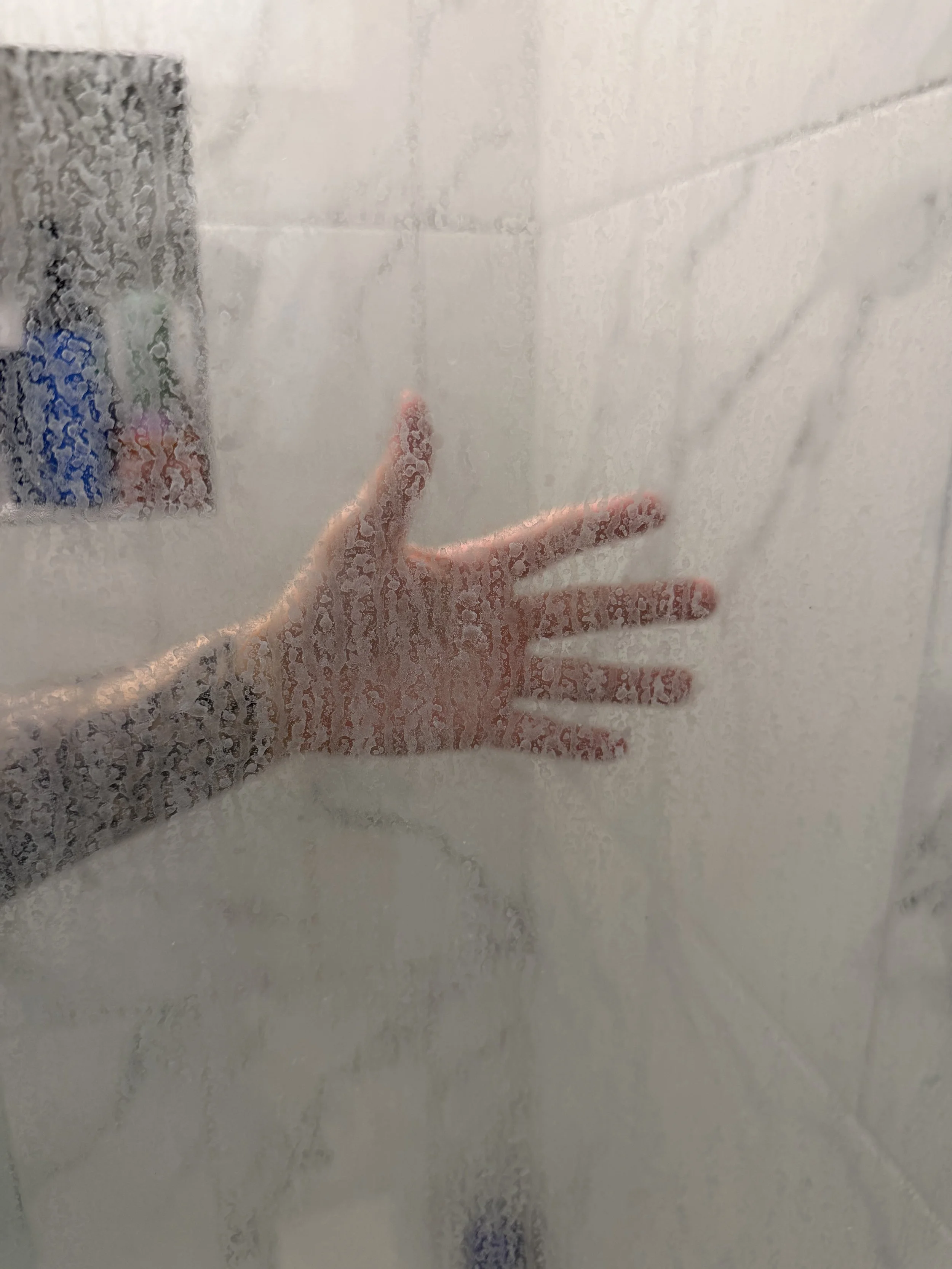 Foggy shower glass door with soap scum and buildup