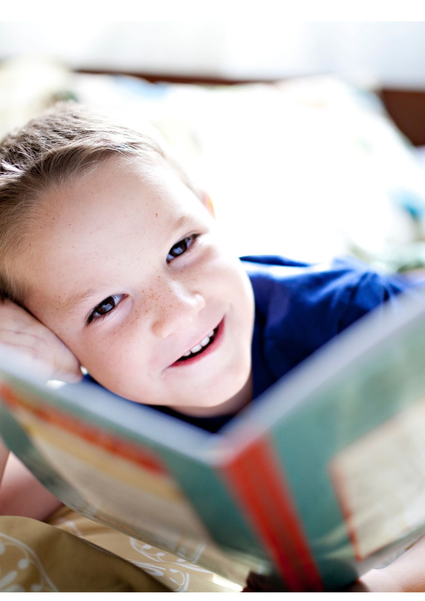 middle-school aged child reading a a book and smiling