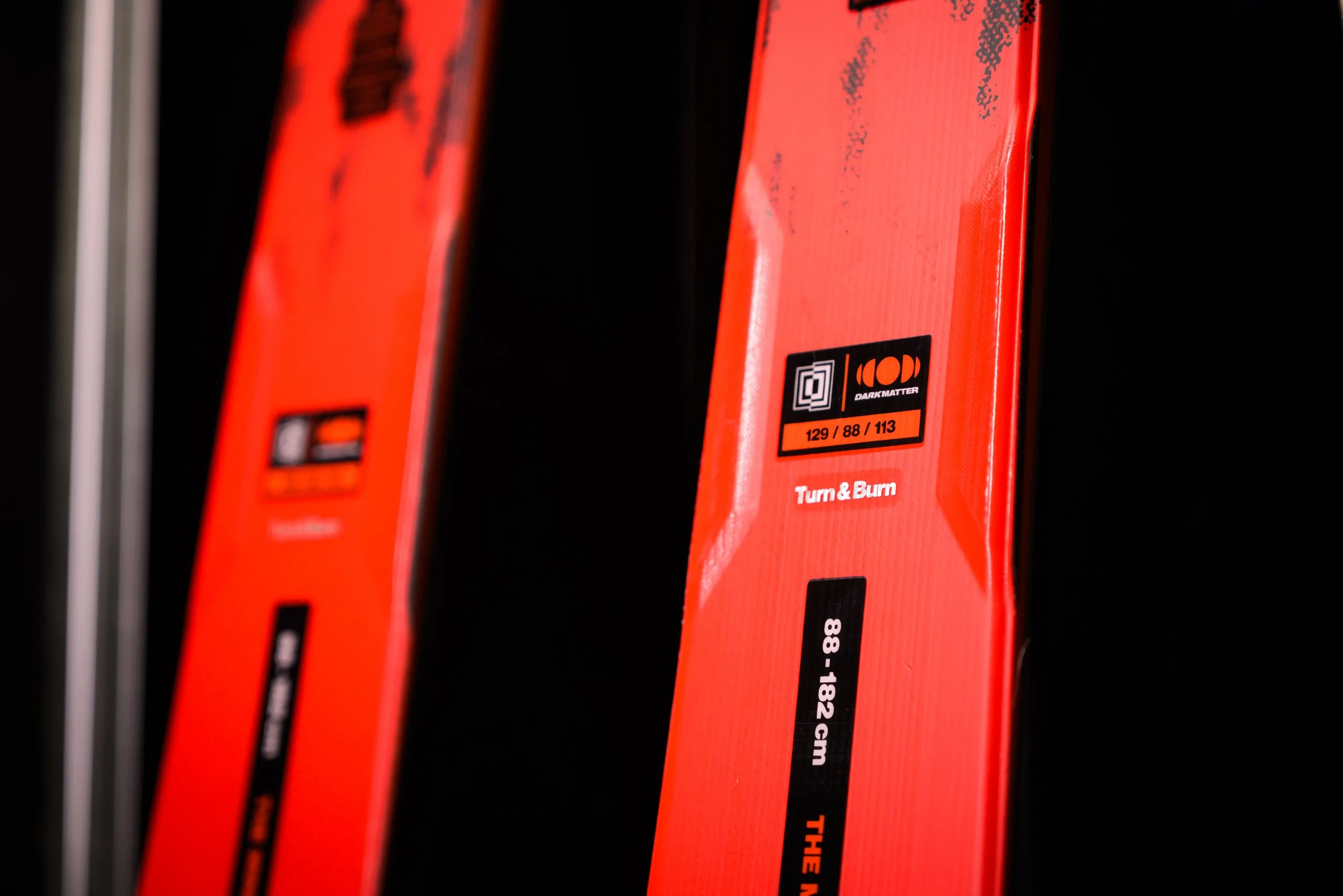 Close-up of red safety matches in a box, with black print and warning labels, positioned along a dark background.