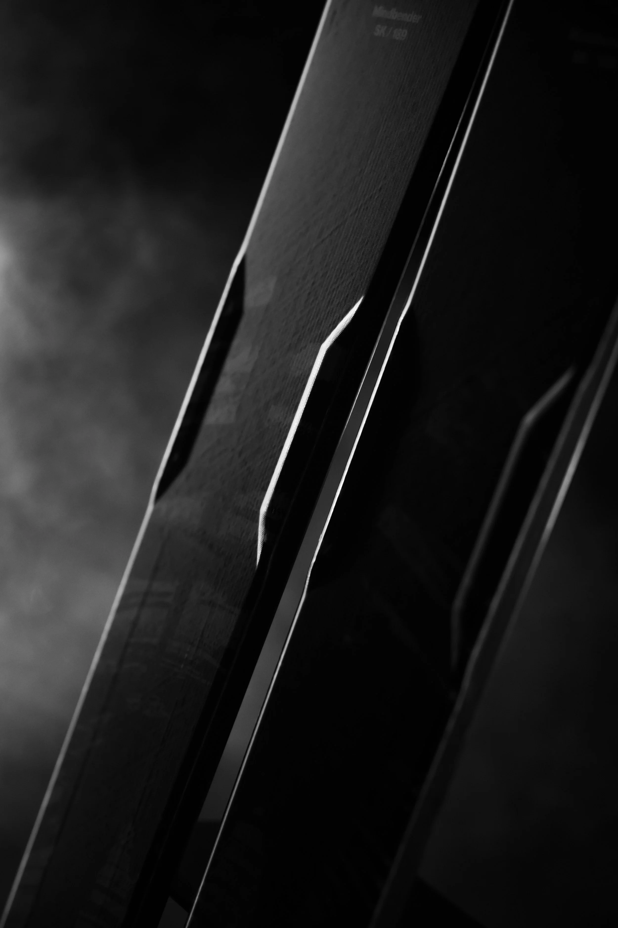 Close-up of a vintage electric guitar with a dark finish, showing the side profile and strings.