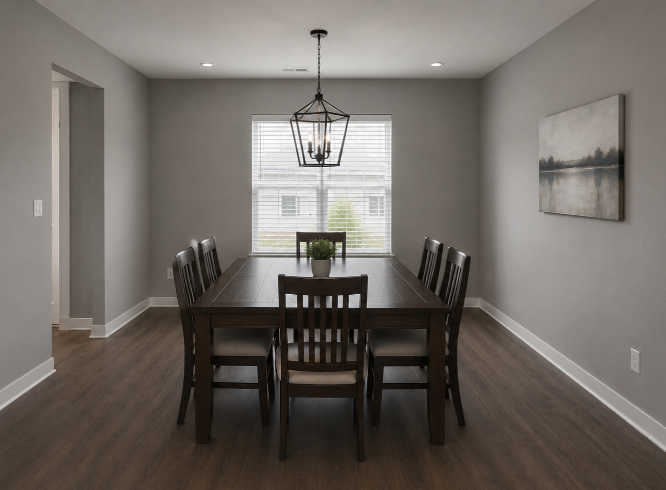 Empty dining room with a dark wood table and six matching chairs, a potted plant in the center, a window with blinds, a hanging lantern-style light fixture, and a landscape painting on the wall.