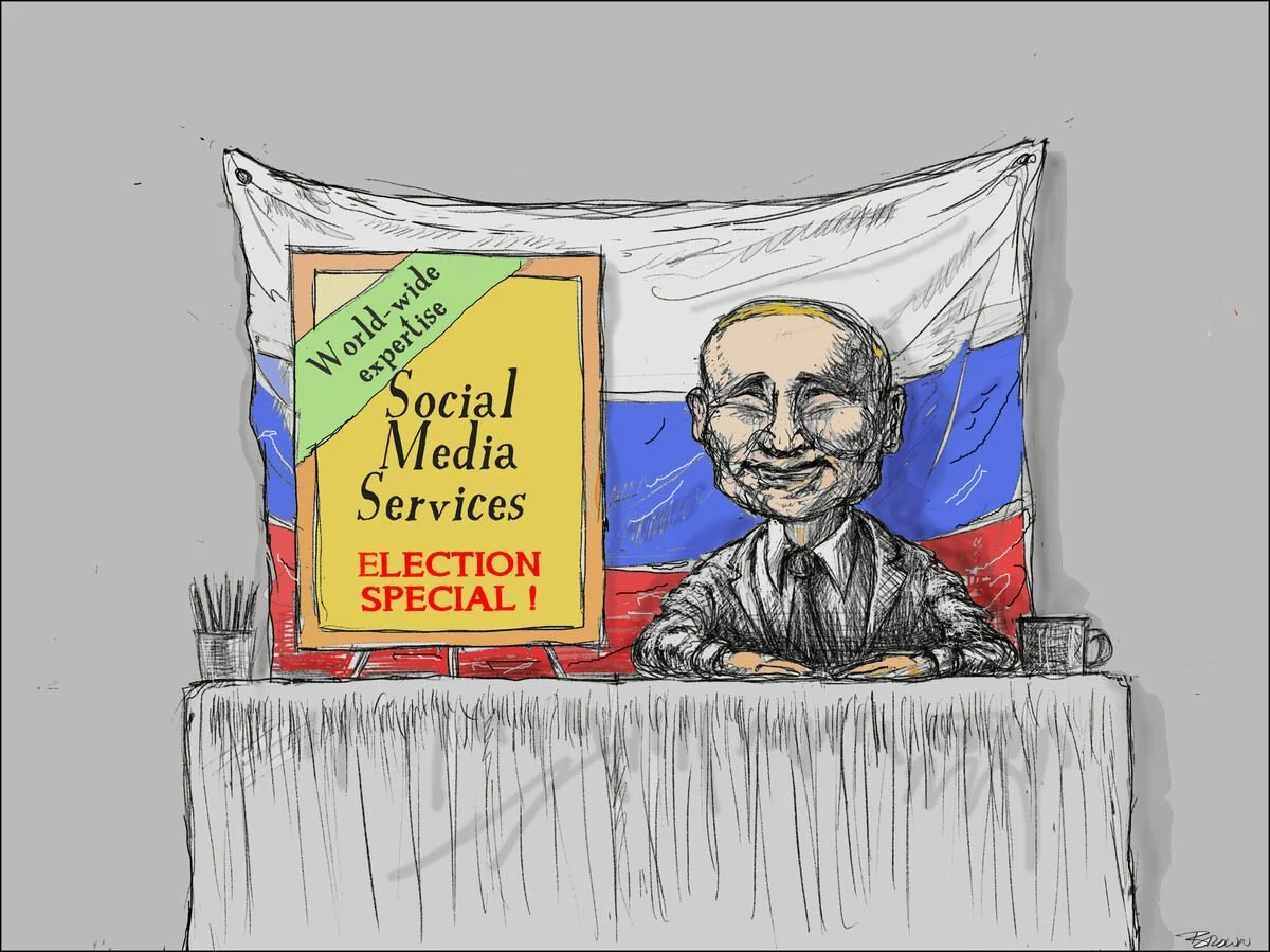 A person with glasses sitting at a desk in front of a Russian flag. There is a sign that reads "Social Media Services, Election Special!" with a green banner that says "World-wide expertise." The desk has a pencil holder, a coffee mug, and a tableclo