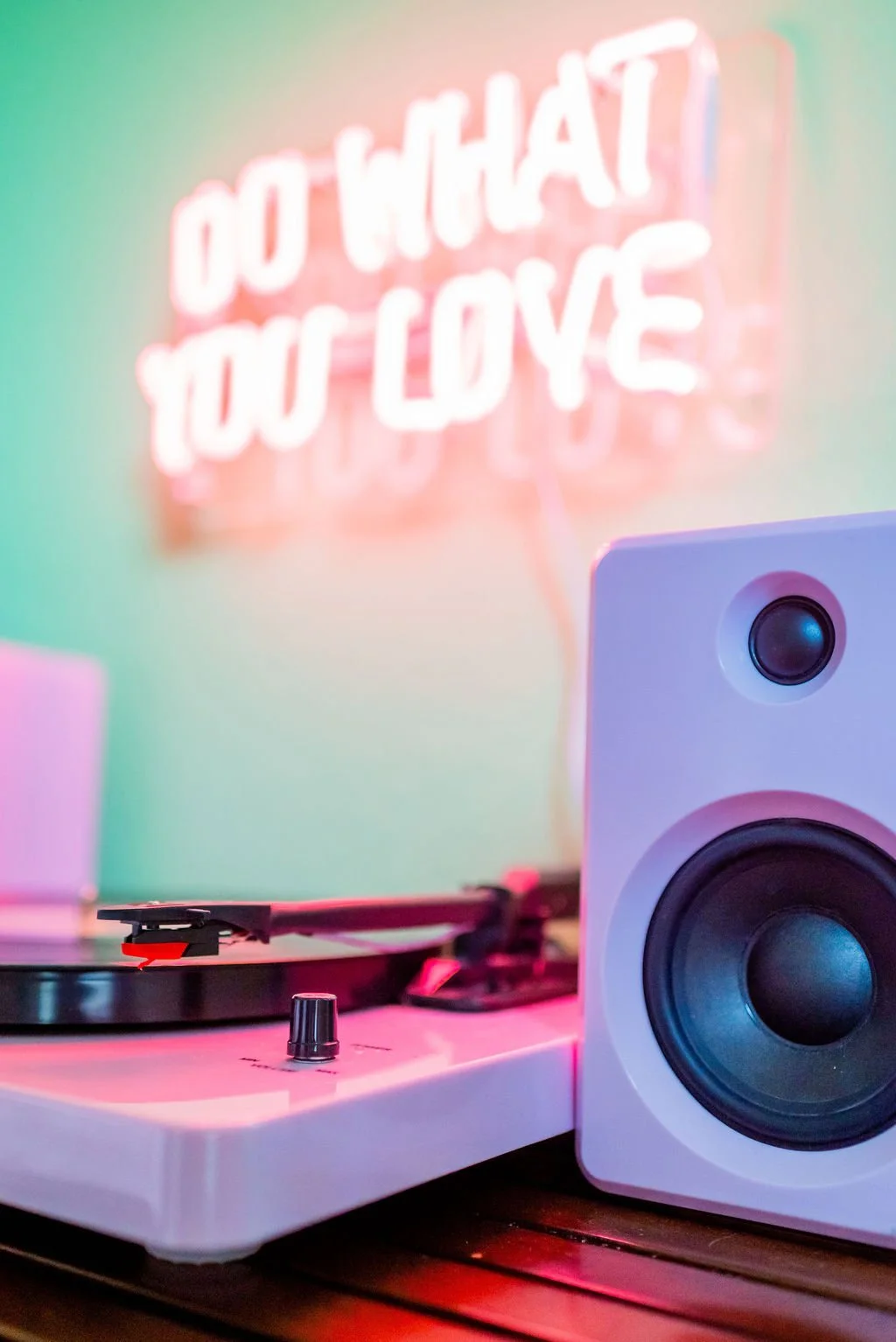 Modern counseling office featuring a pink record player and neon "Do What You Love" sign, representing a supportive space for navigating relationships, boundaries, and life transitions.