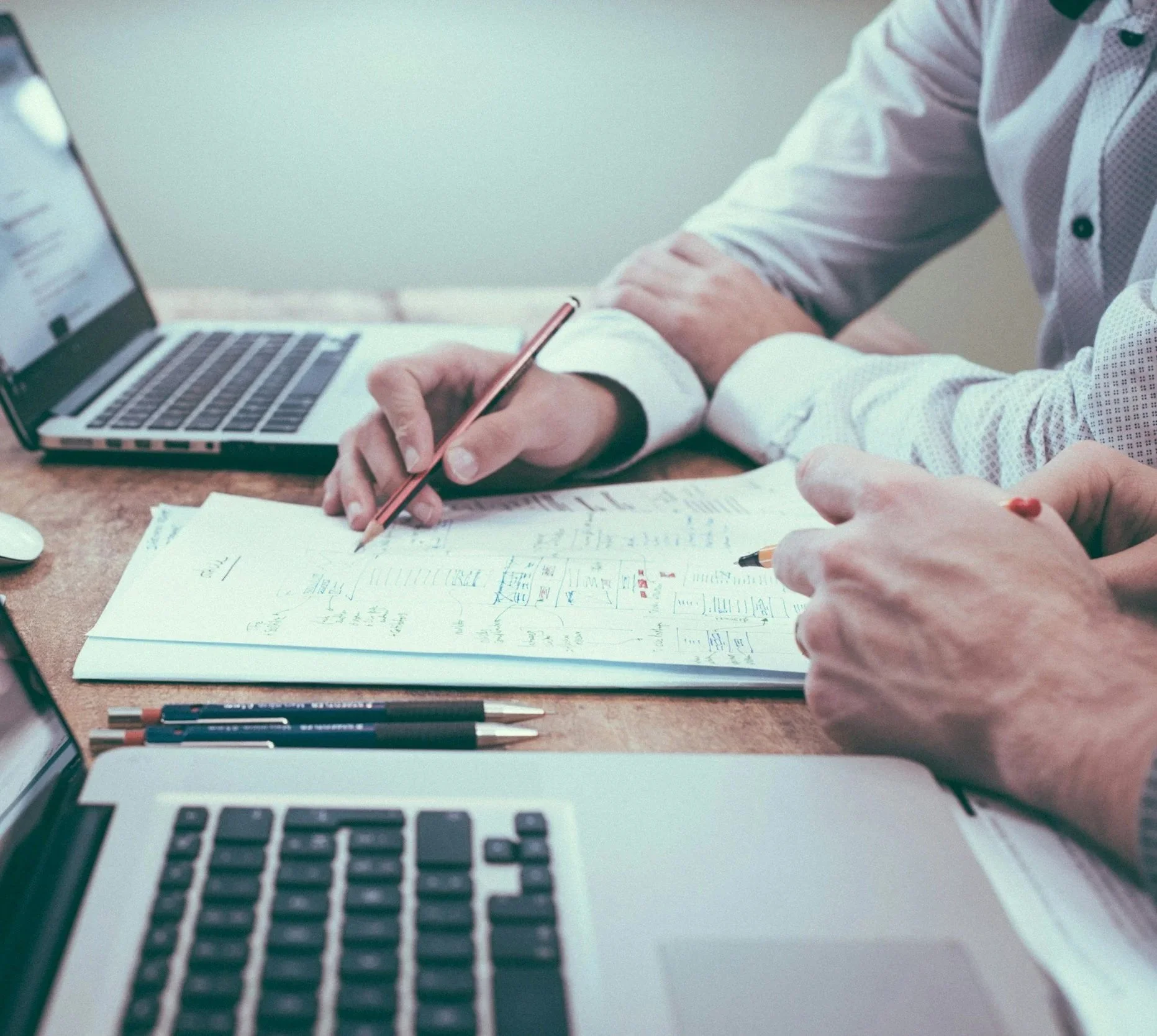 Two colleagues reviewing financial aid data reports together at a desk