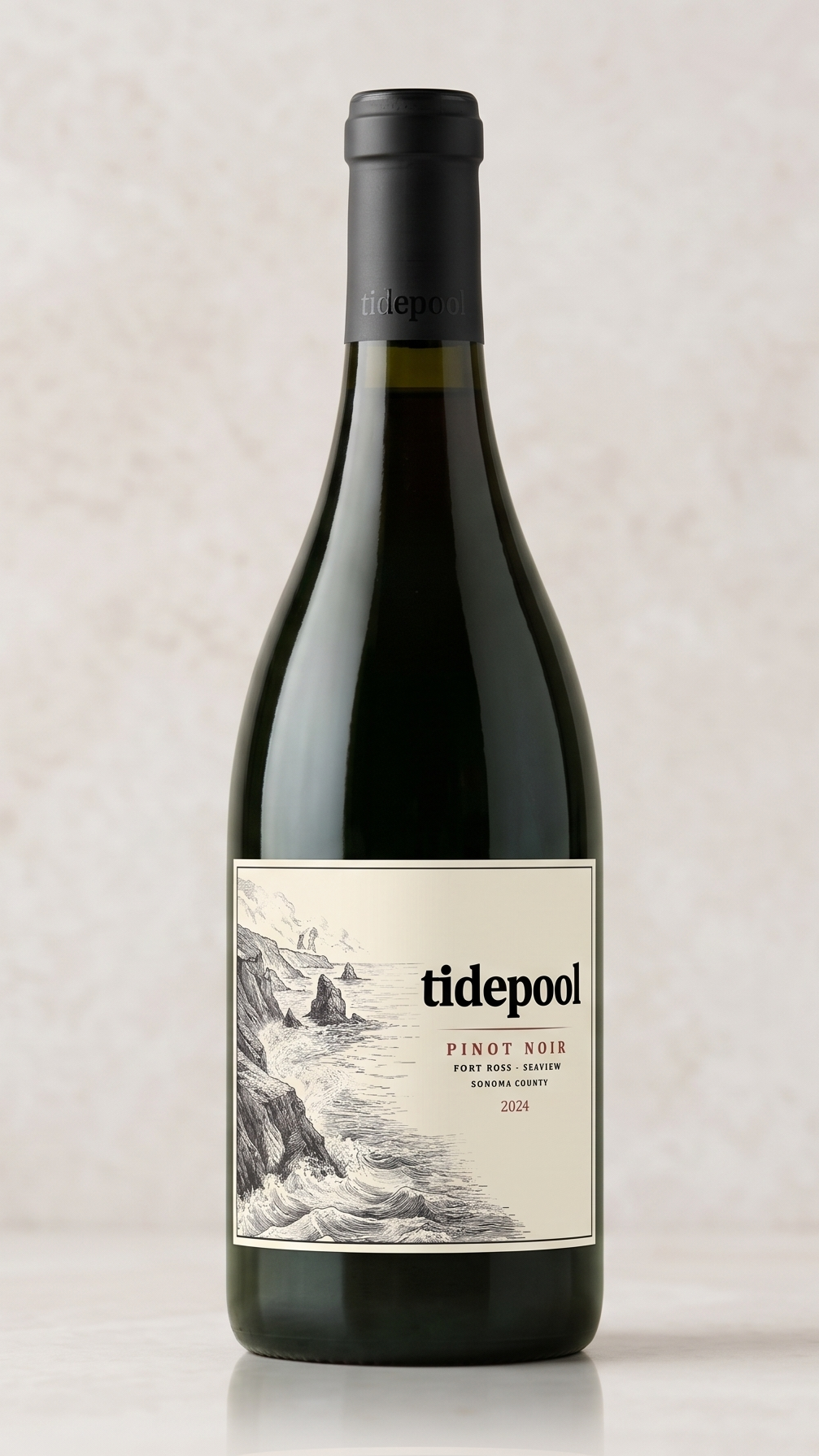 A dark green bottle of Tidepool Pinot Noir wine with a black cap and a cream-colored label featuring a black-and-white illustration of rocky sea cliffs and water, with text indicating the wine is from Fort Ross-Sea View, Sonoma County, 2024 vintage.