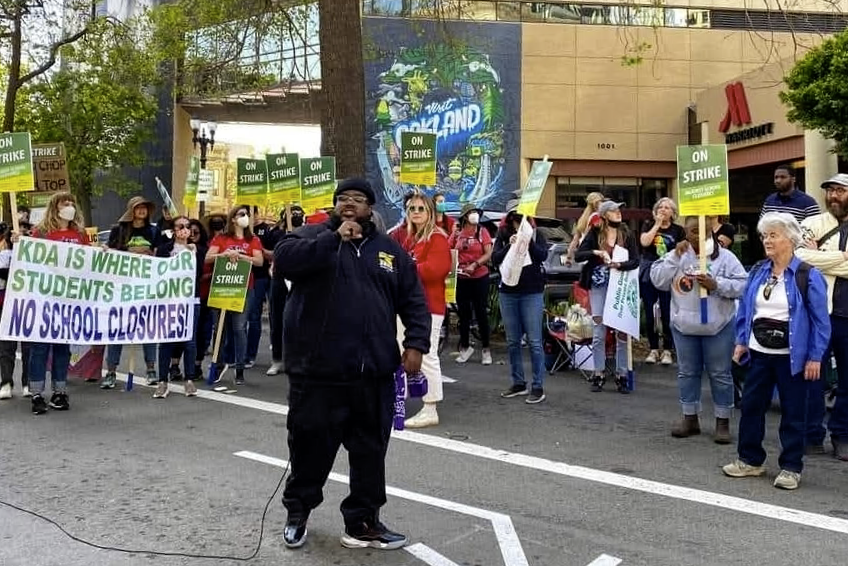 An image of Brandon Dawkins rallying against school closures in Oakland.