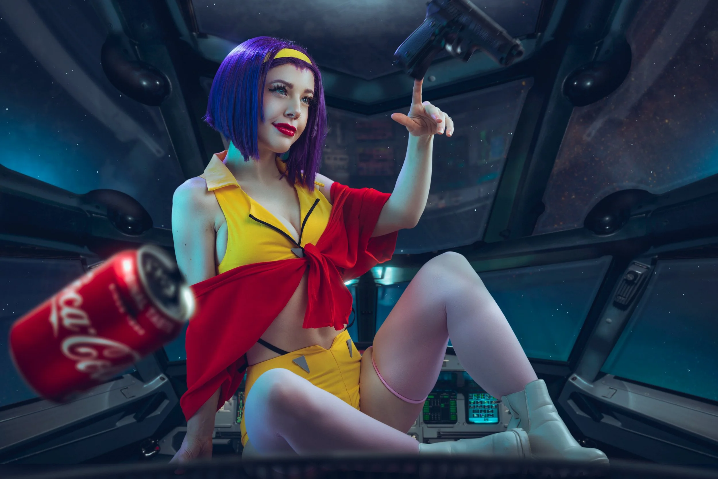 Woman with purple hair in a yellow and red outfit inside a spaceship cockpit, holding a gun, with a galaxy background.