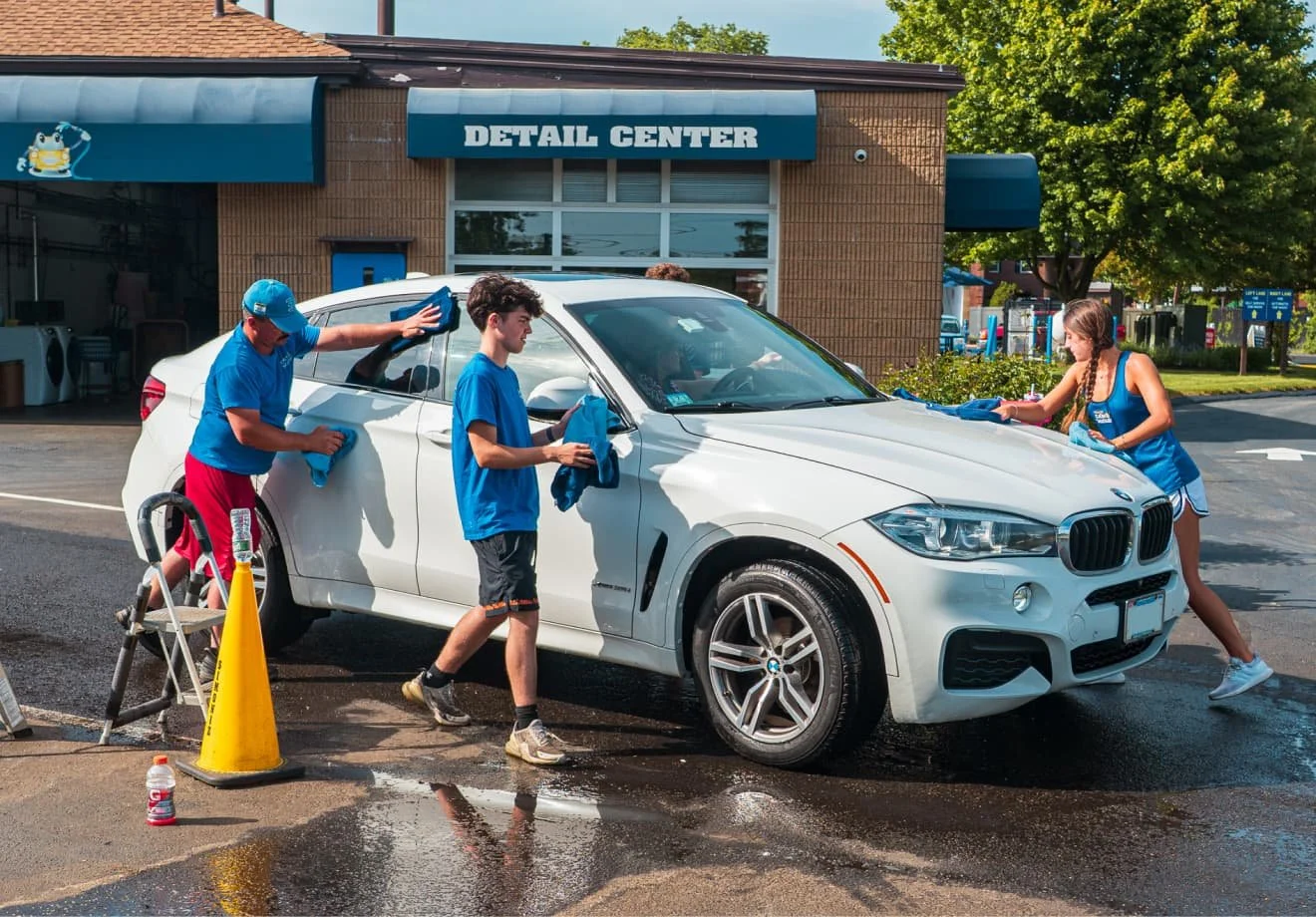 Franklin Car Wash team cleaning a customer’s vehicle