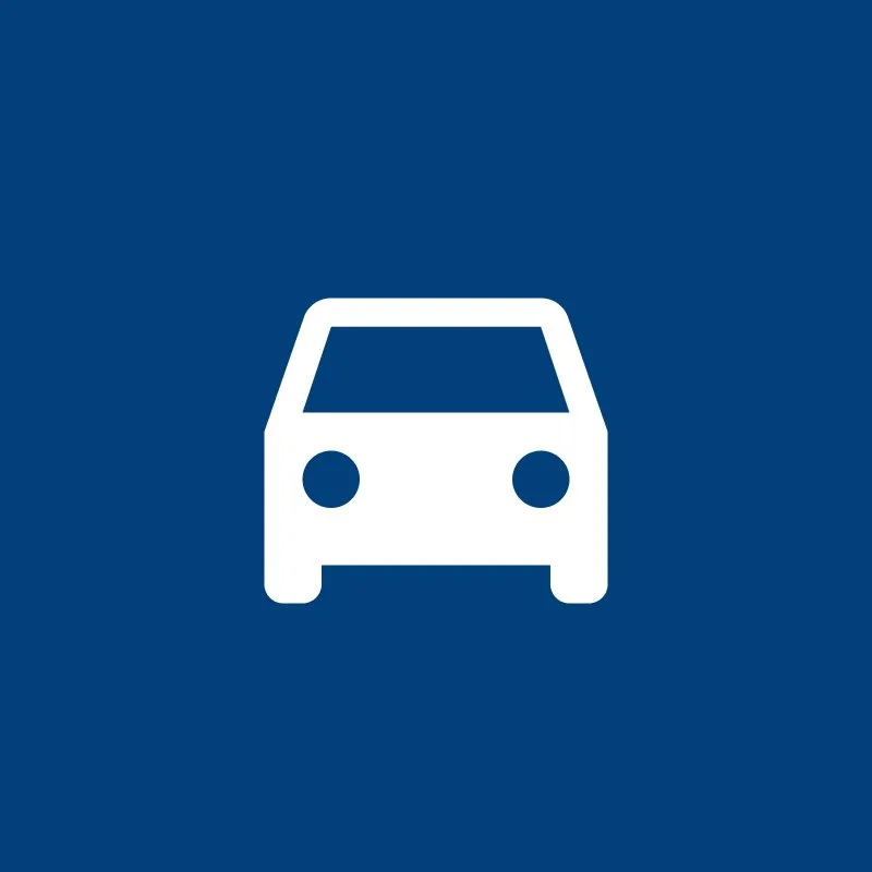 Icon of a white car on a blue background, indicating a parking or vehicle area.