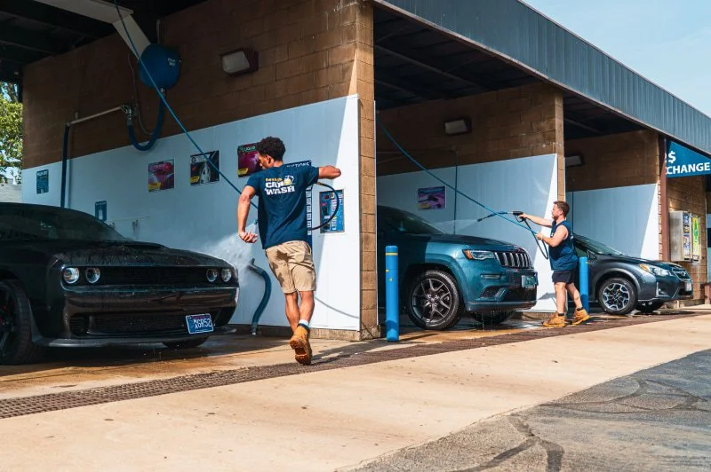 Customers washing their vehicles in the self-service bays at The Franklin Car Wash