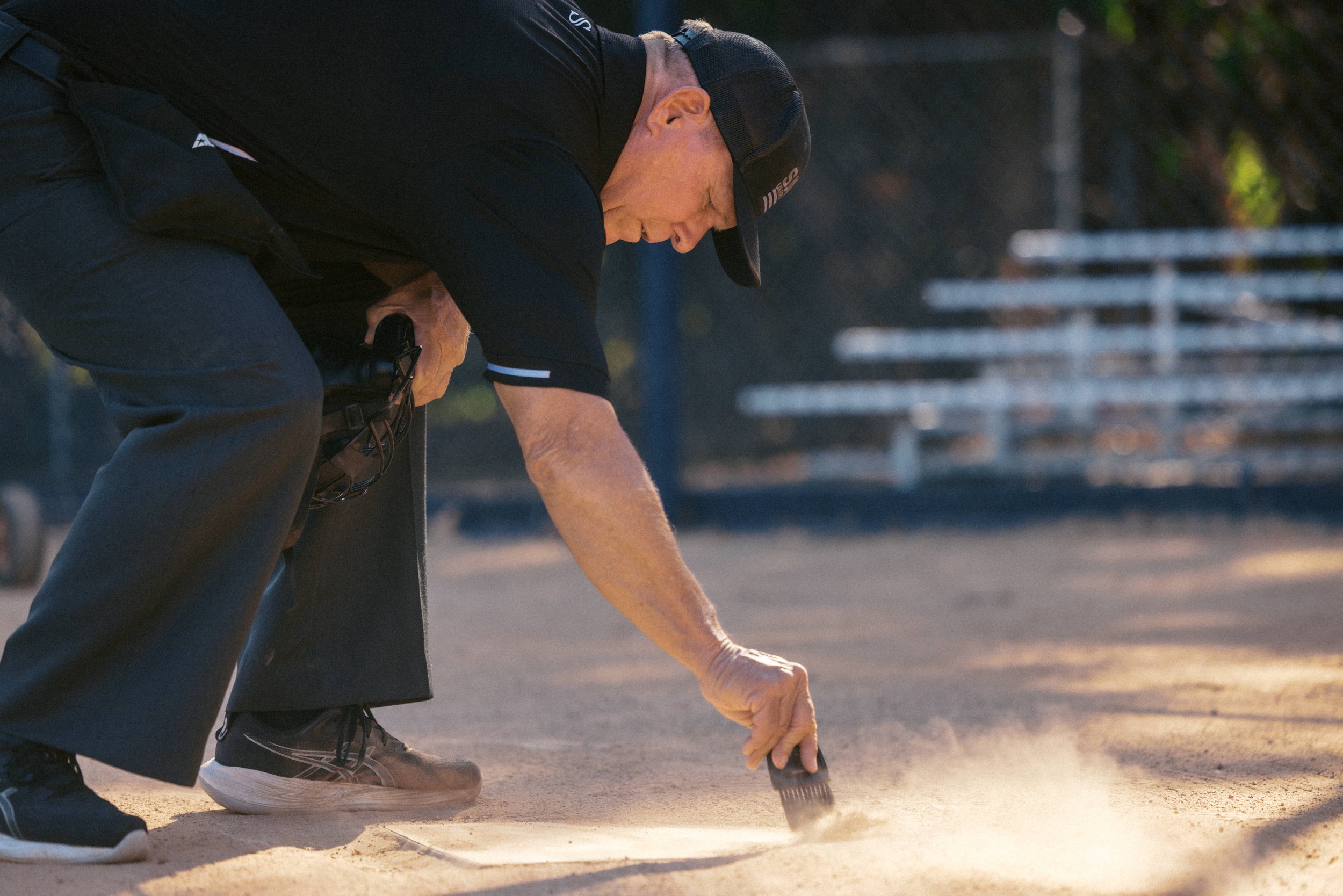 Jeff, as a baseball umpire, clearing home plate 