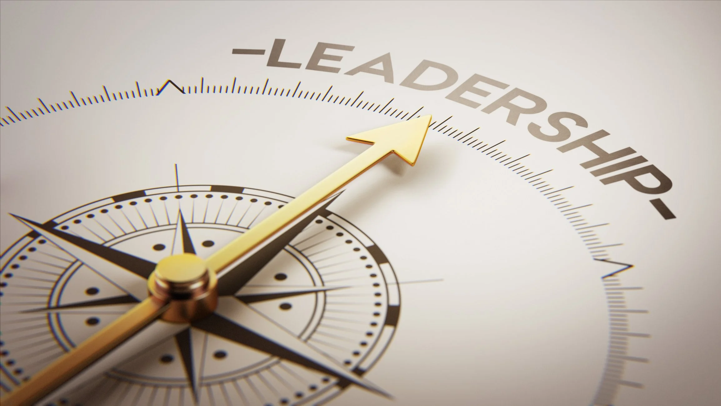 Close-up of a compass with a gold arrow pointing towards 'LEADERSHIP' on a gauge, symbolizing direction and guidance.