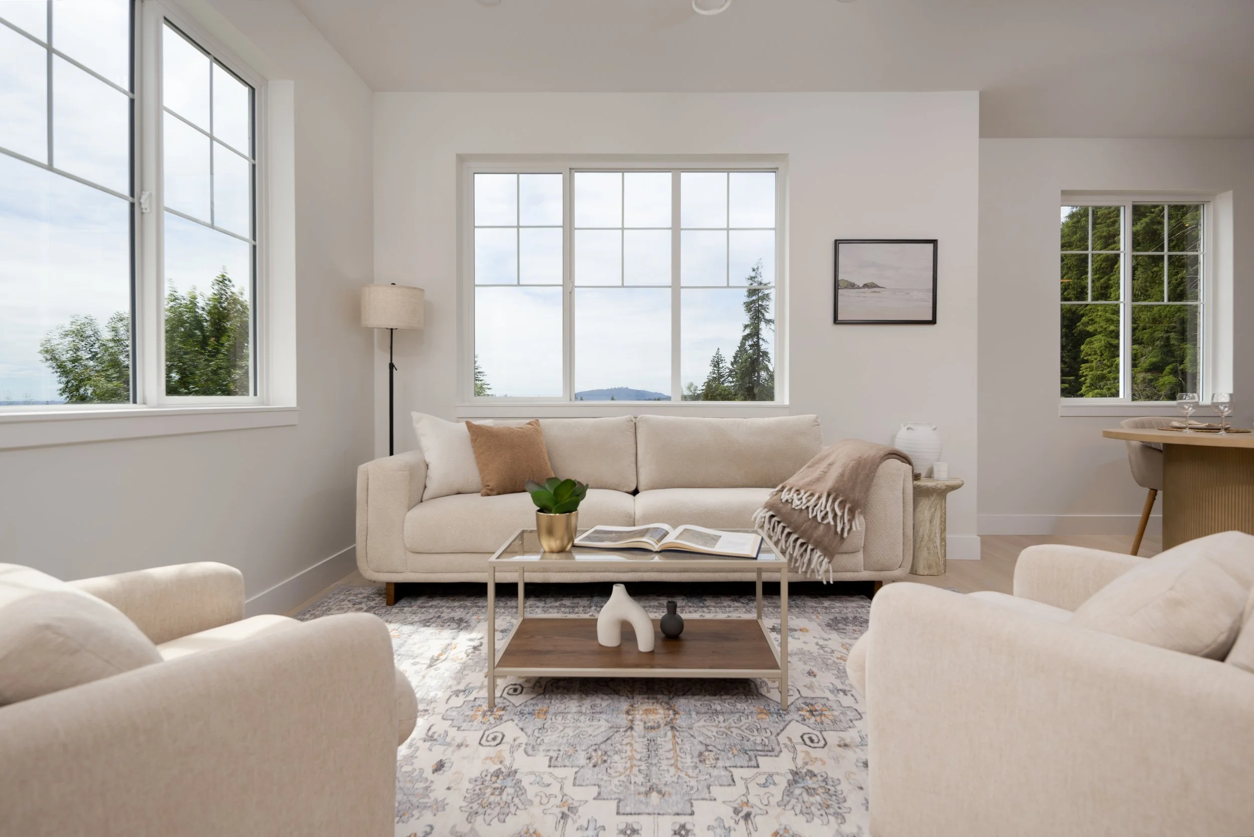 Bright open-concept living room in a Clermont townhome with large windows and scenic Burke Mountain views.