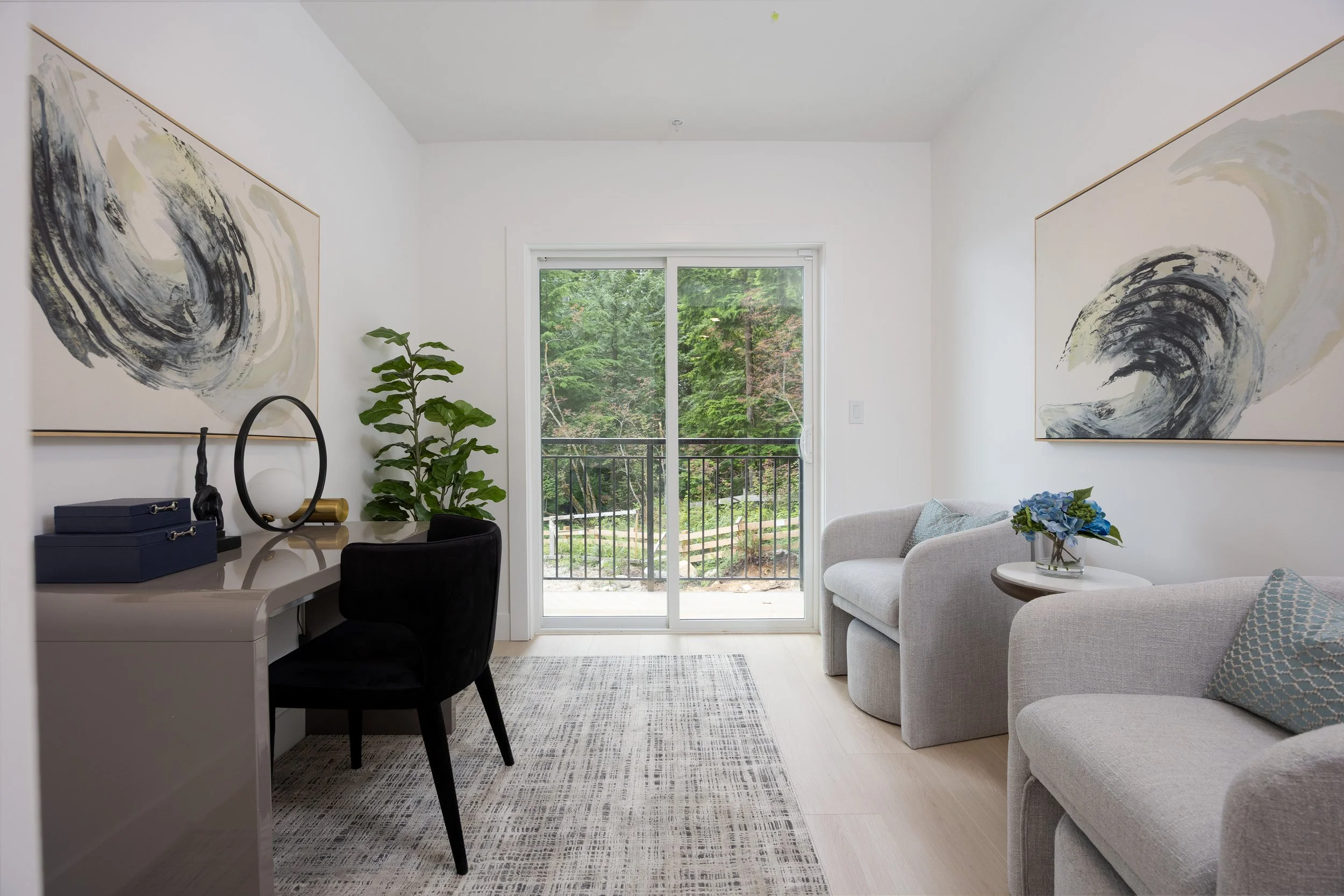 Flexible recreation room staged as a modern home office with balcony access in a Clermont townhome.