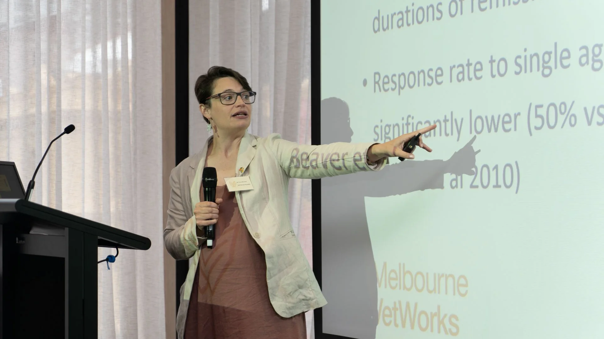 A veterinary oncologist speaking to further education in the field.