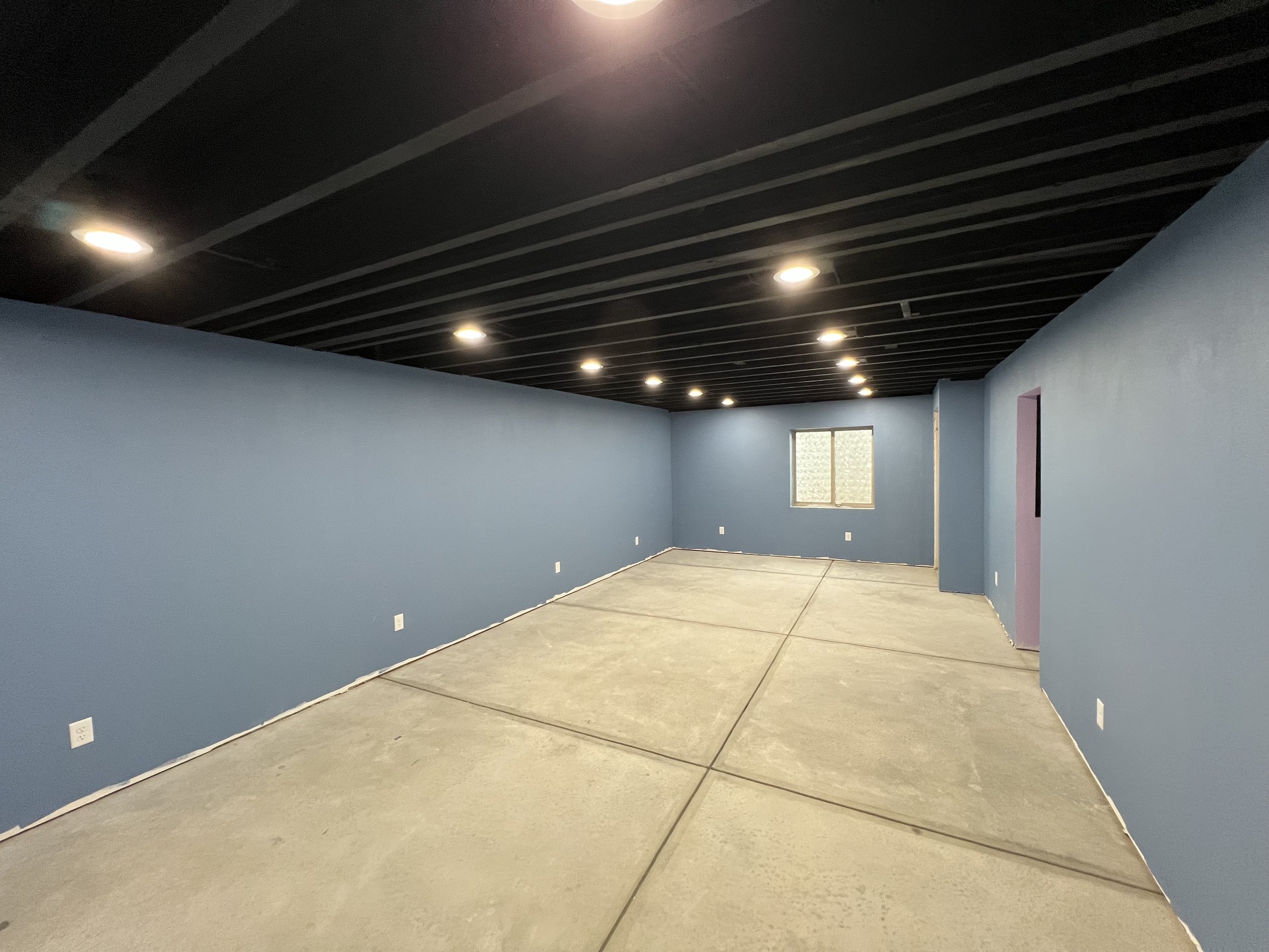 Finished basement with recessed LED lighting installed by Al's Electric in Windsor, Colorado