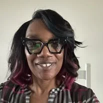 Barbara Wilson, owner of Grace & Getaways Travel LLC, smiling for a professional portrati.