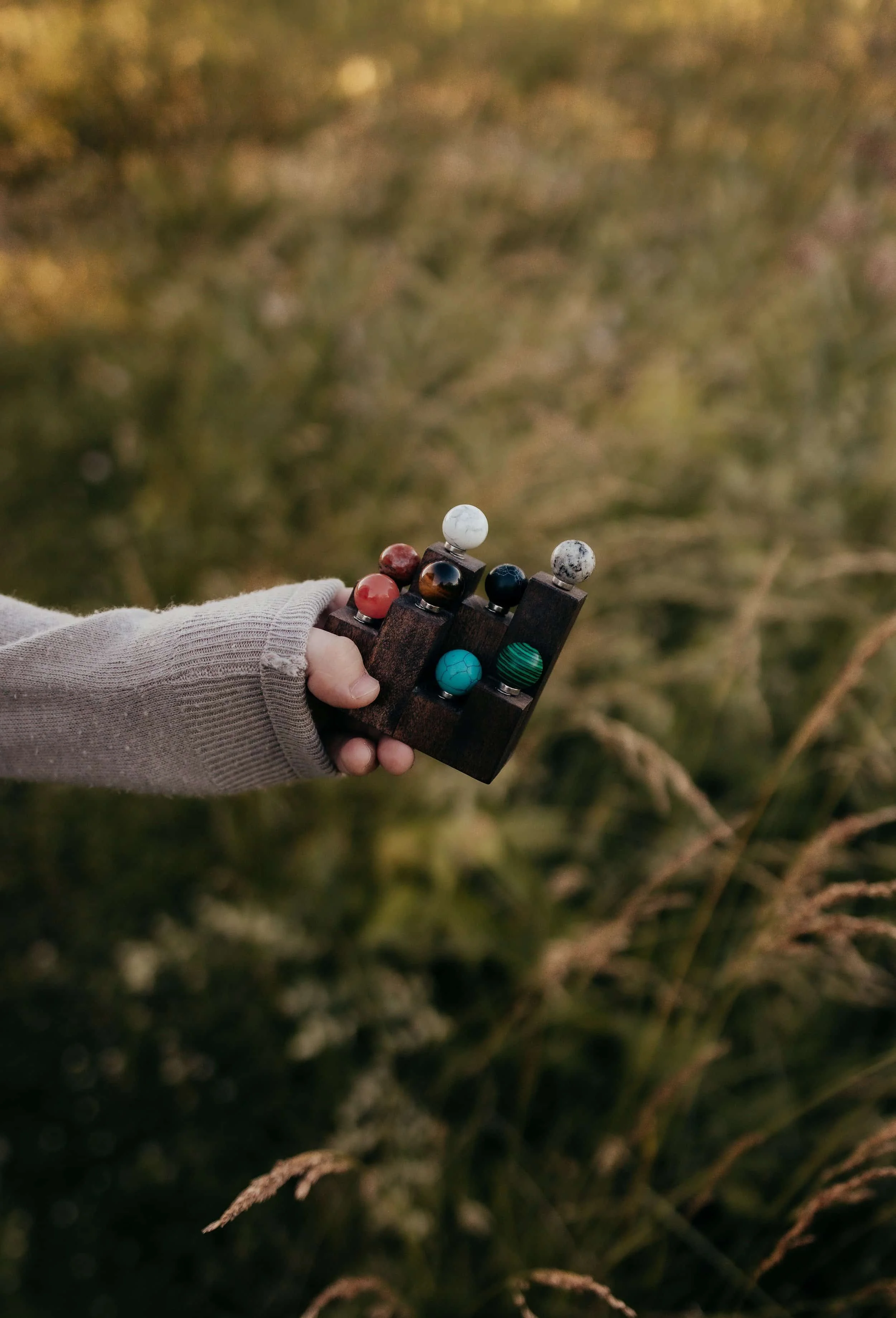 A person holding a Brainspotting pointer in an outdoor grassy area.