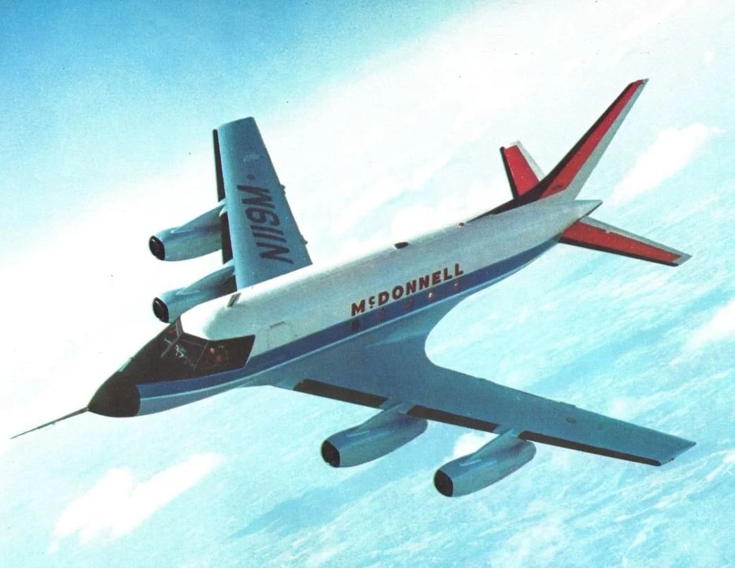 Vintage McDonnell Douglas airplane with multiple engines, flying through a clear sky with a few clouds.