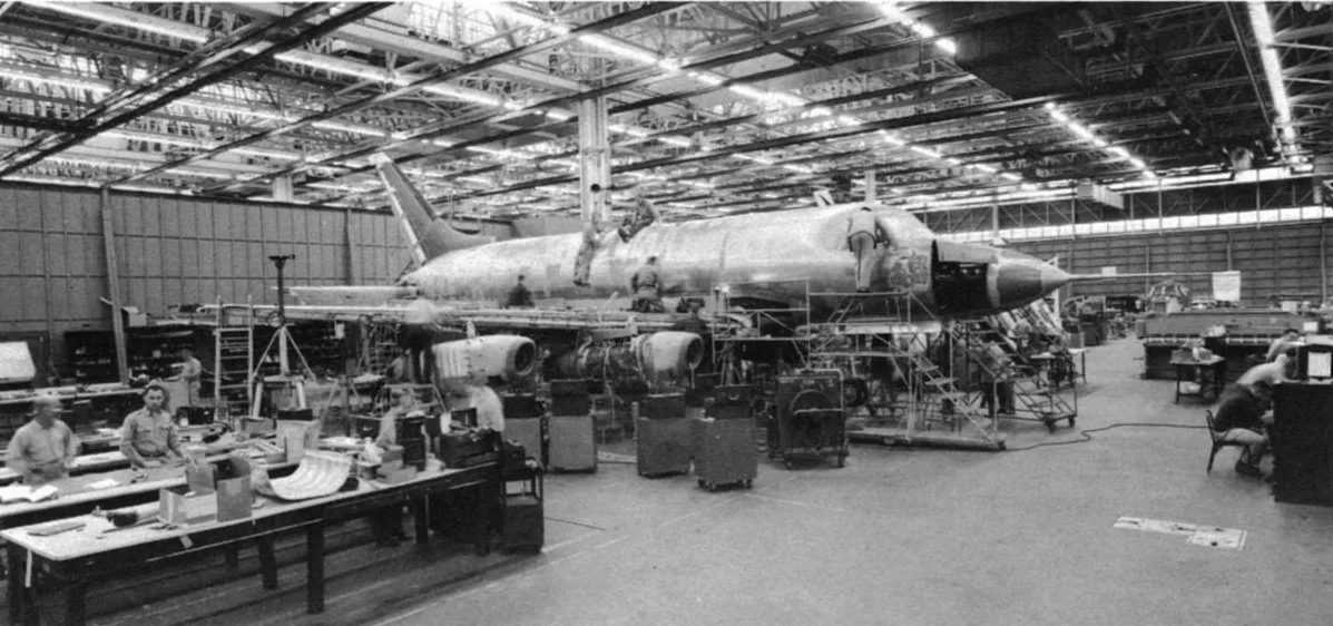 The McDonnel 119/220 sits on the factory floor at The McDonnell Aircraft Corporation in St. Louis, MO.  Around it stands the engineers, mechanics, and other personnel who built the aircraft that would one day become known as The Albuquerque Phoenix.
