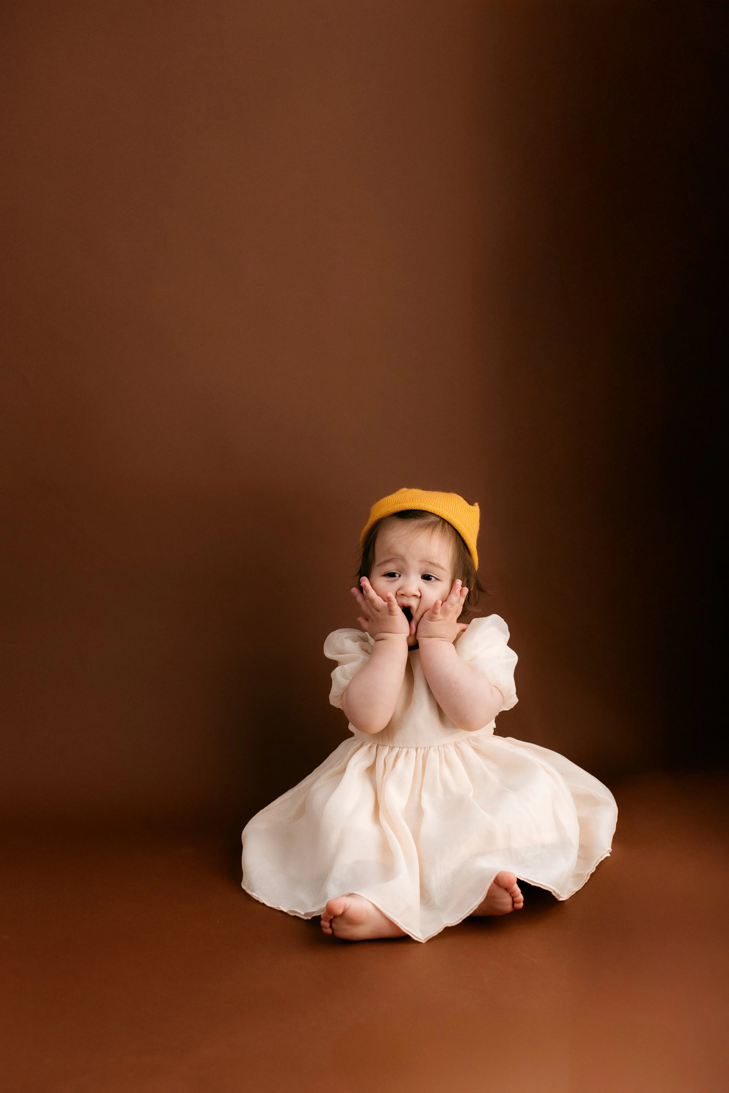 Melbourne milestone photography capturing a baby’s joyful personality in a timeless studio portrait.