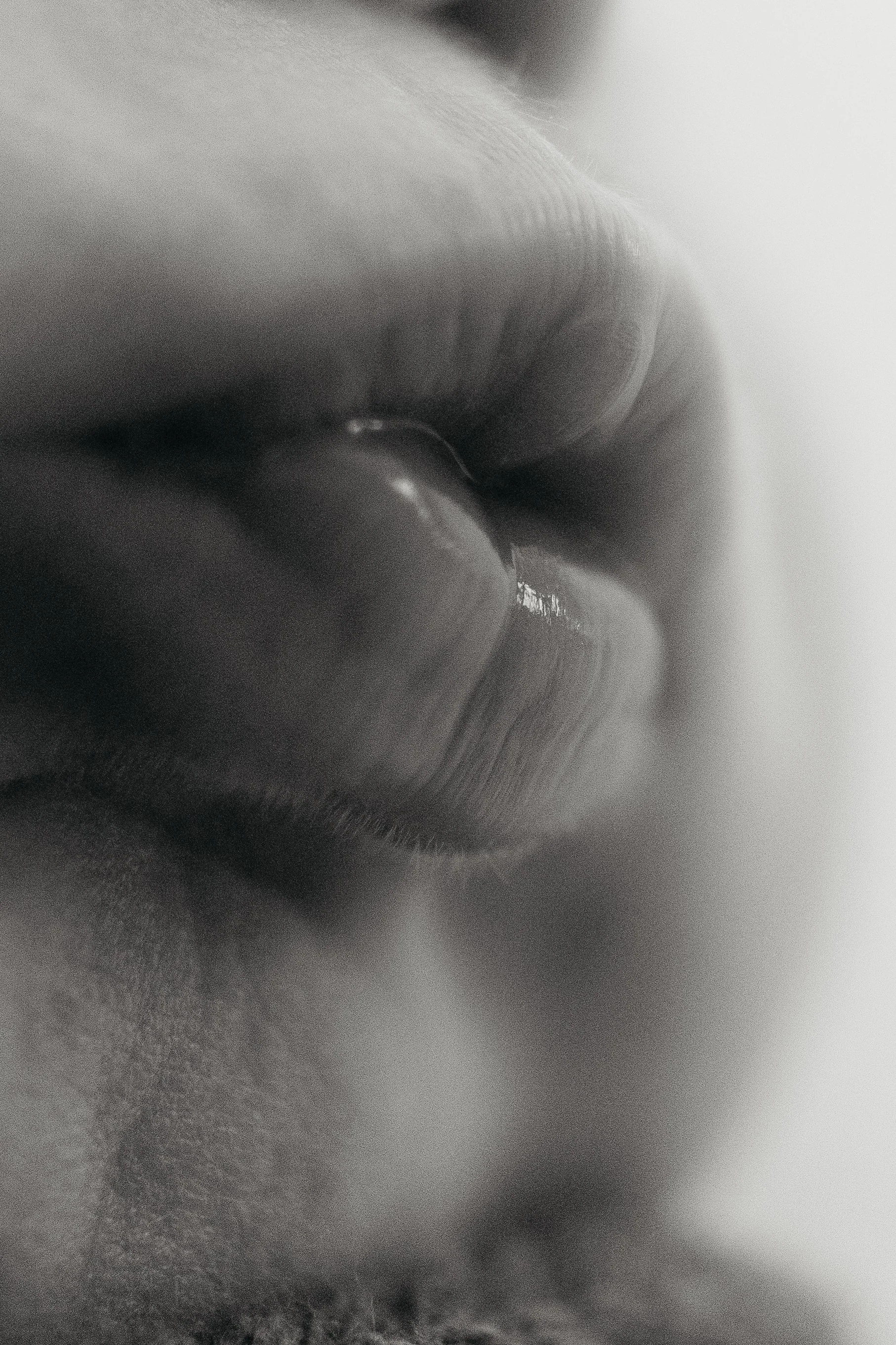 Close-up black and white photo of a person's lips.