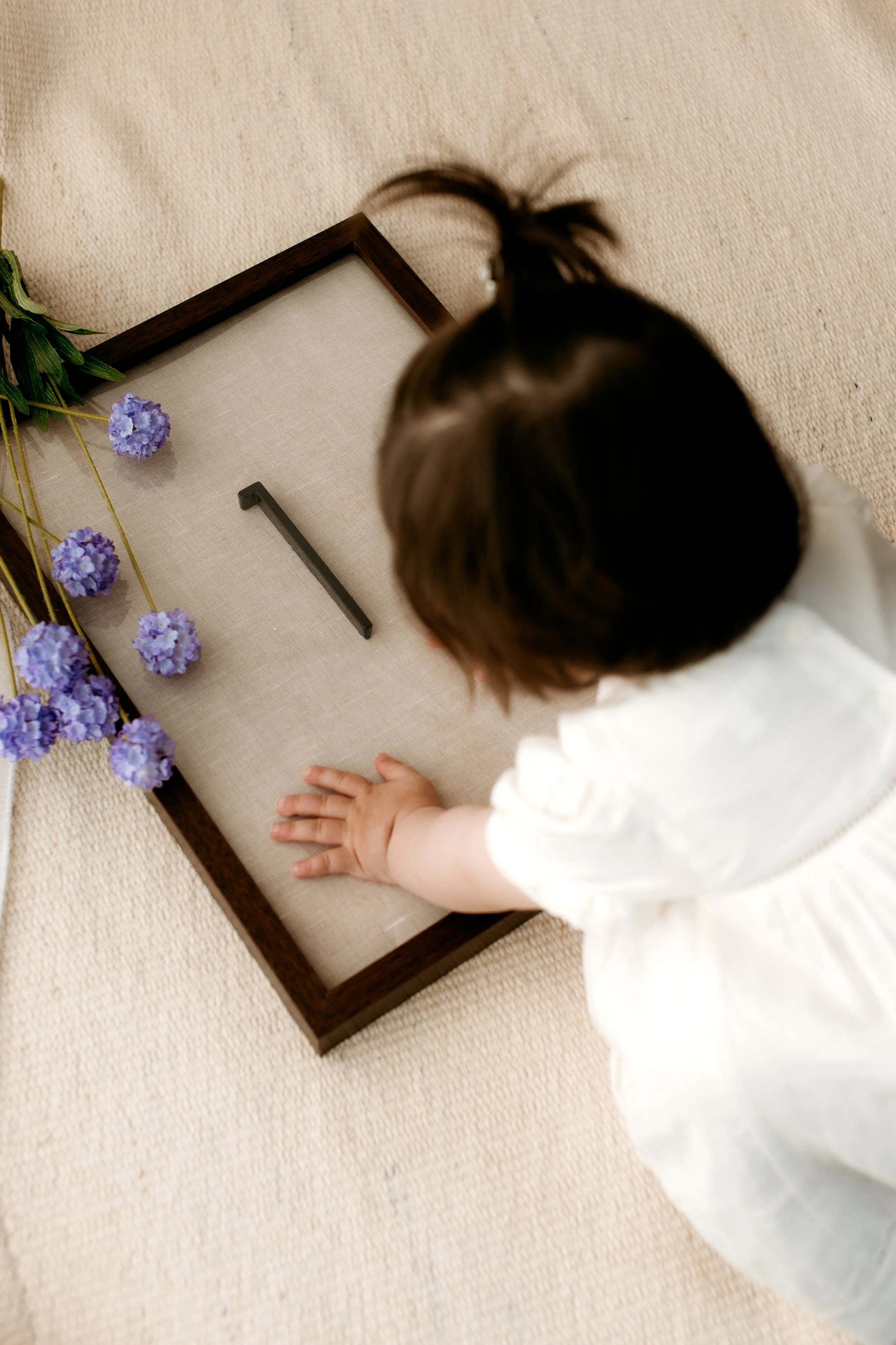 Child exploring a calm, family-friendly photography studio in Dandenong North, Melbourne before a portrait session.