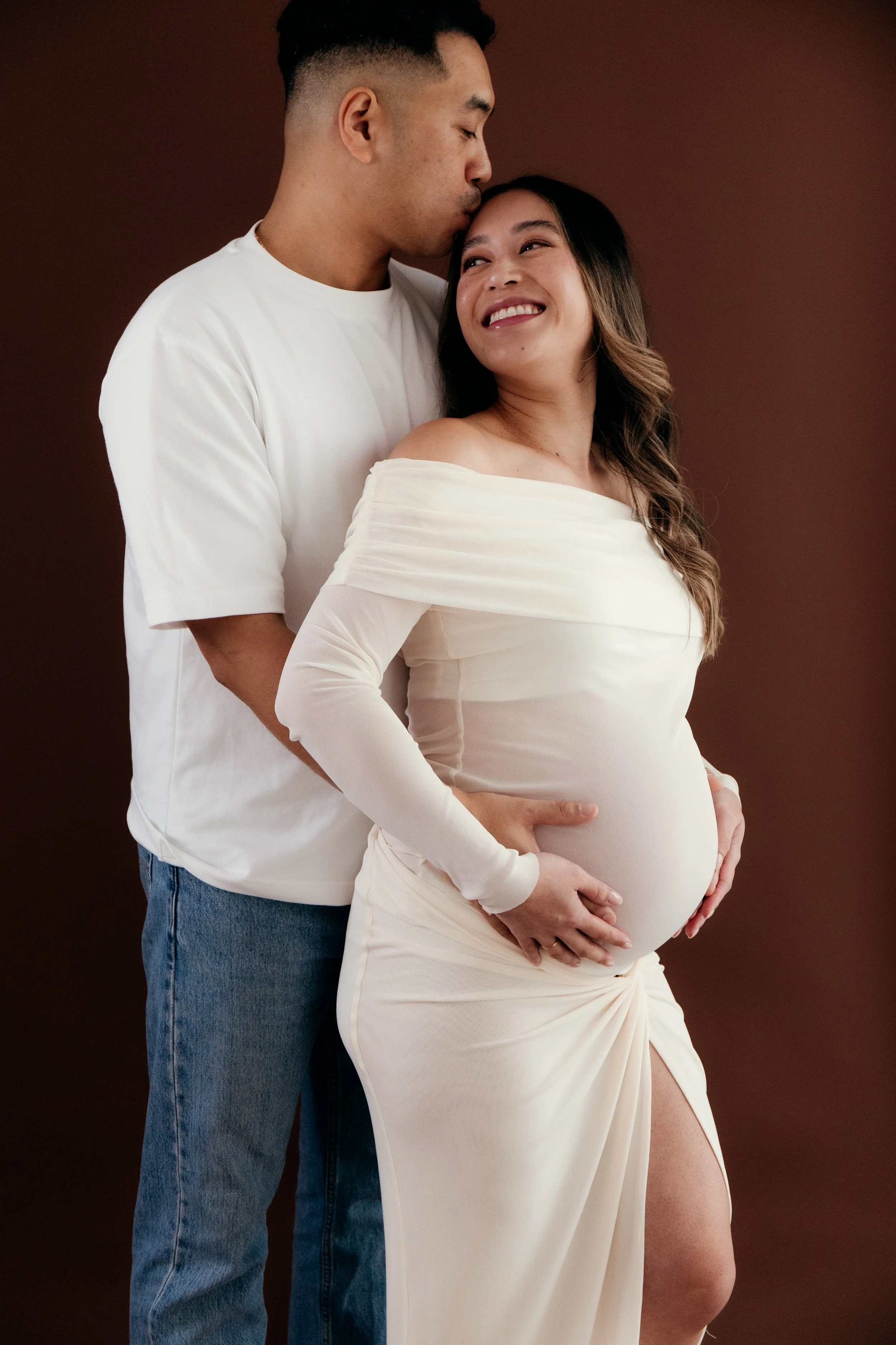 Luxury maternity photography in Melbourne featuring an expectant couple sharing an intimate moment in an elegant editorial portrait.