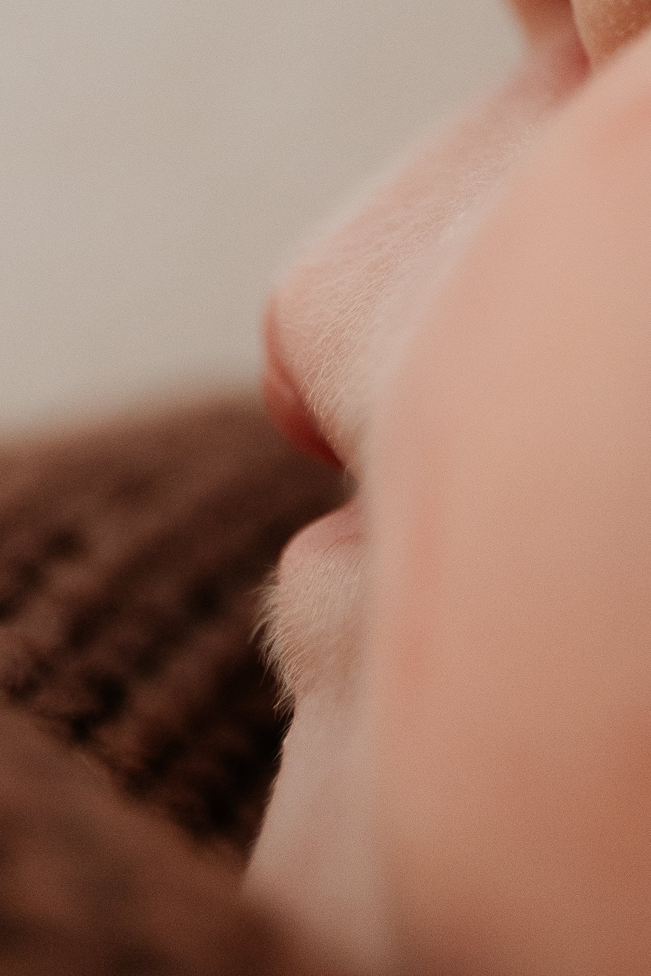 Close-up of a person's nose and a portion of their face with a digitally added 3D cube pattern in the lower left corner.
