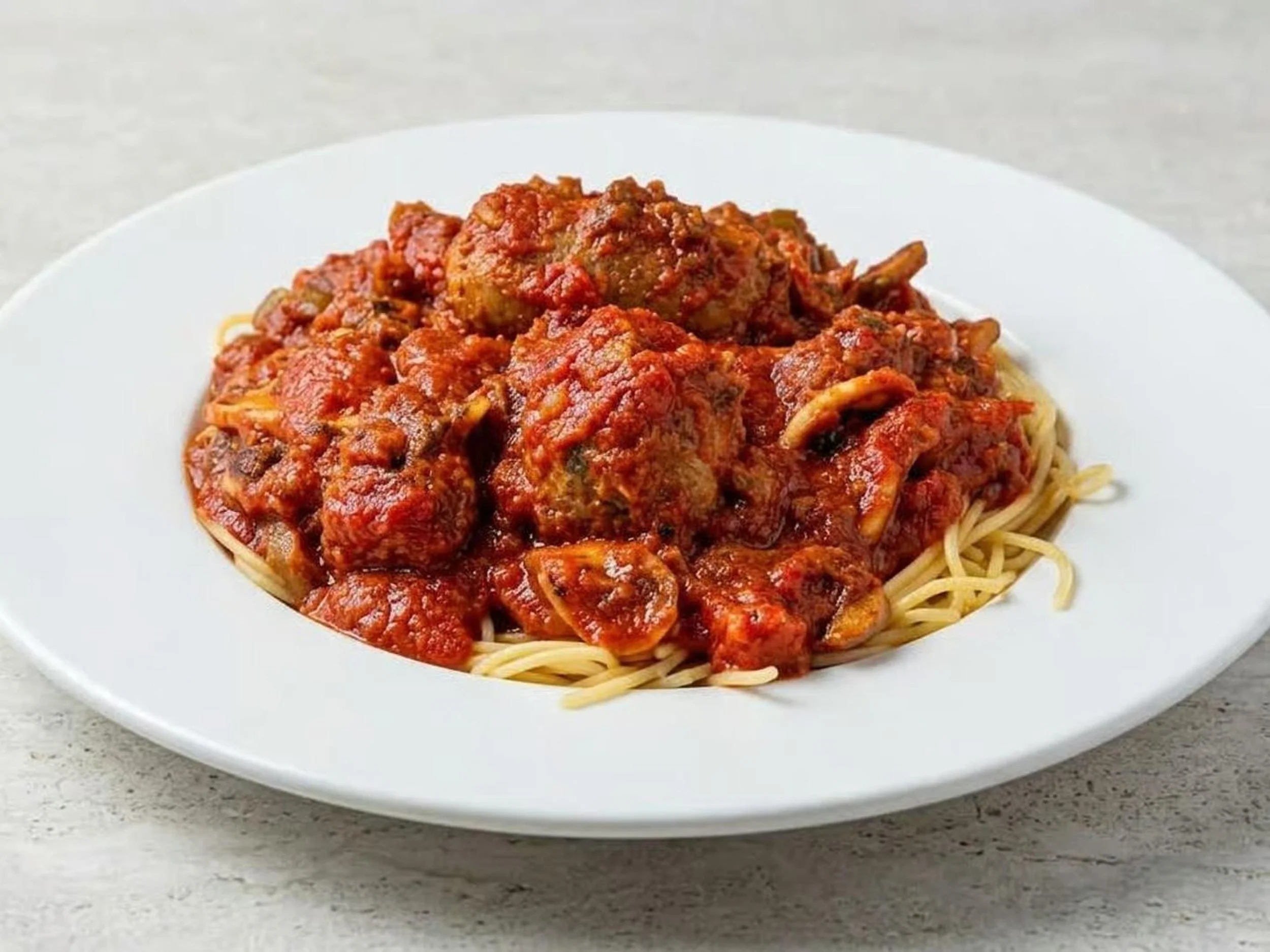 Spaghetti with meat sauce on a white plate.