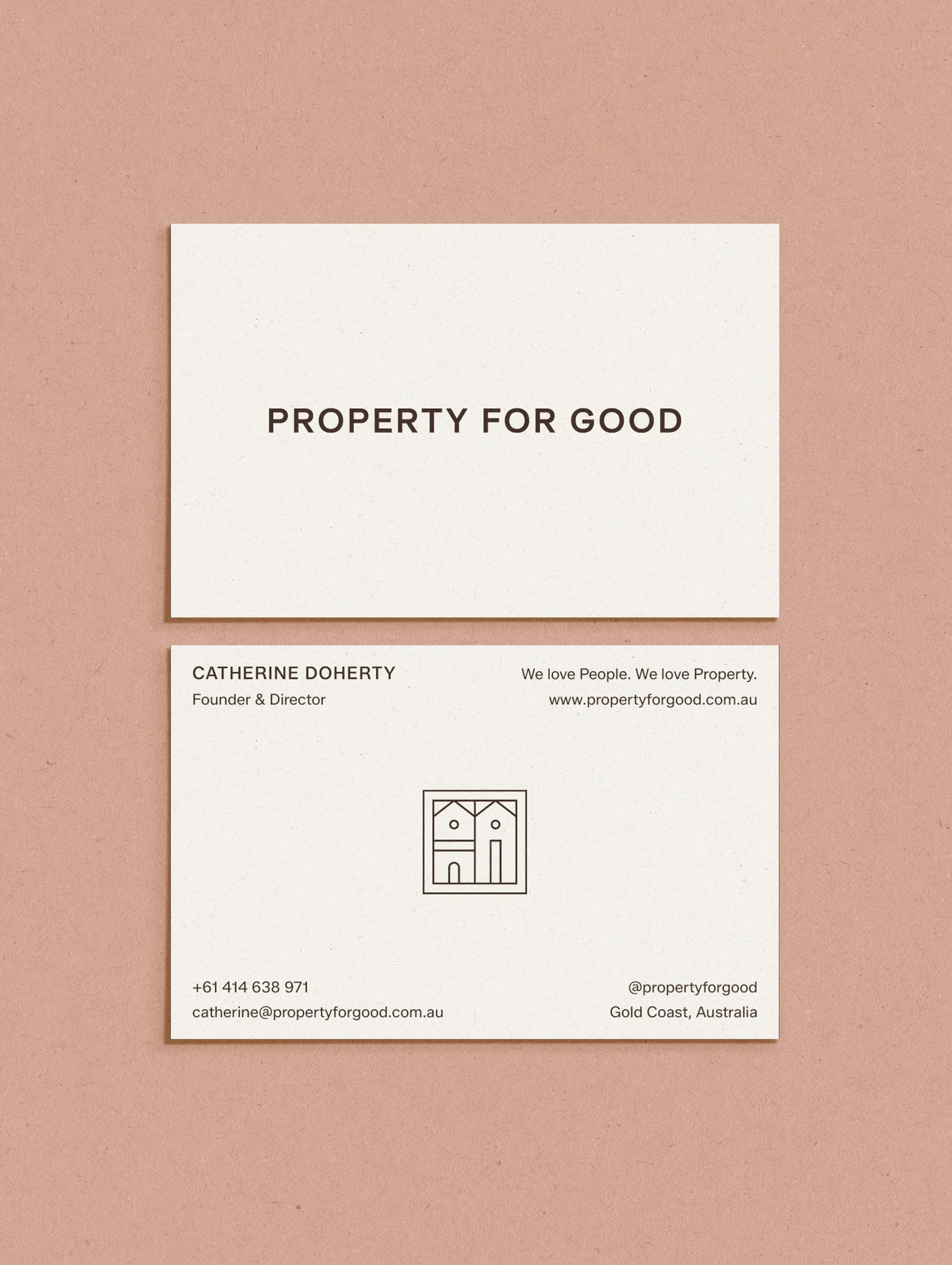 Business card with the text 'Property for Good' and contact information, including phone number, email, address in Gold Coast, Australia, placed on a pink surface.
