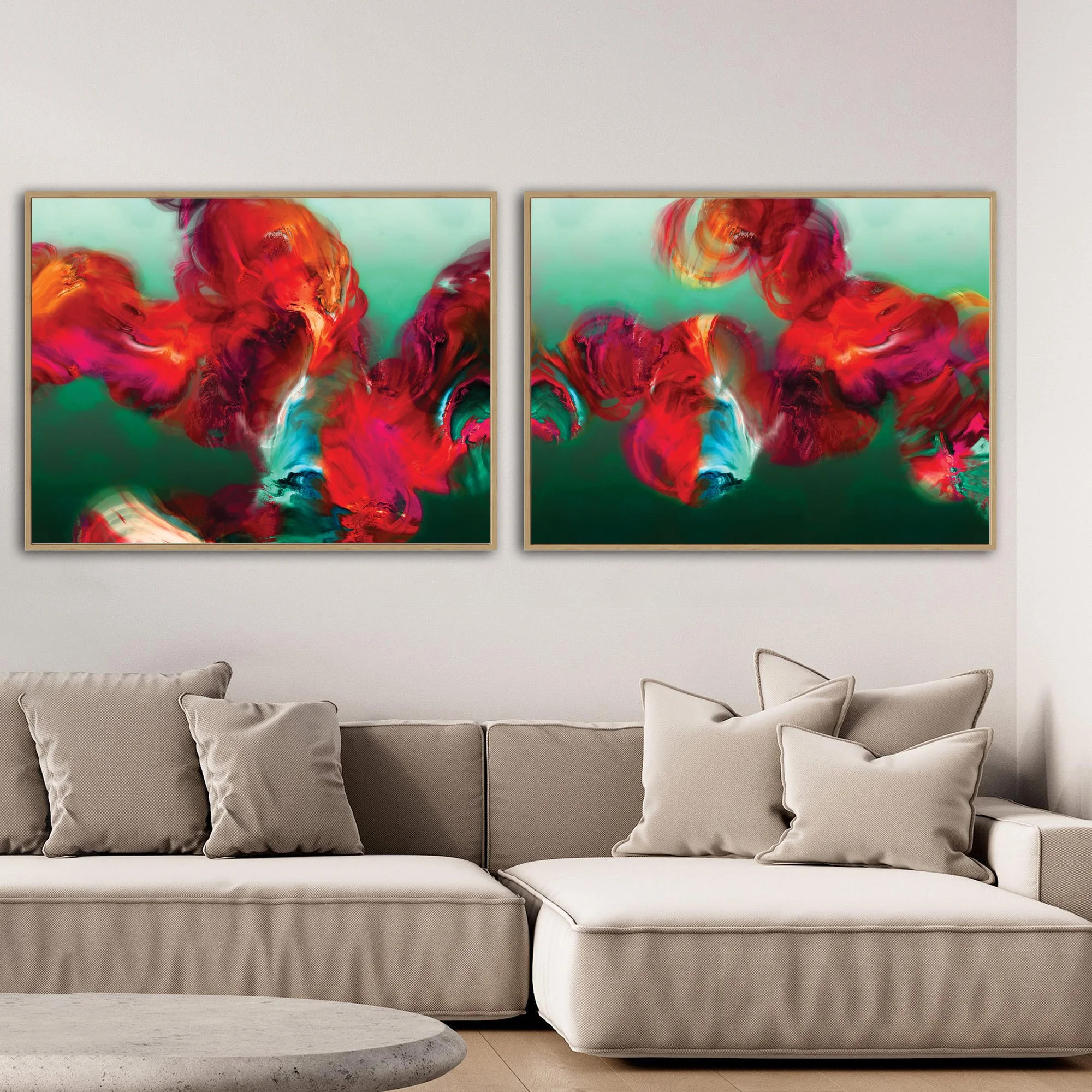 Abstract diptych with textured, cloud-like fluid shapes in fiery red, magenta, and bright ocher against a deep emerald green and teal background, framed and ready to hang. Over grey sofa