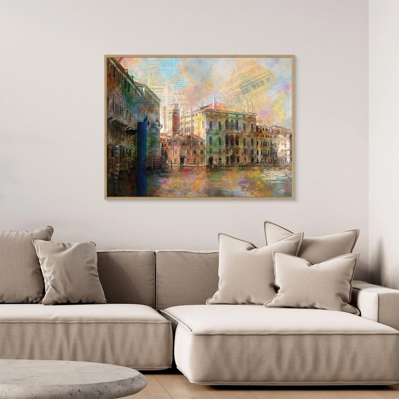 Fine art print collage of Venice featuring historic palazzo architecture overlaid with vintage newspaper clippings and vibrant watercolor textures, framed and ready to hang. Over grey couch