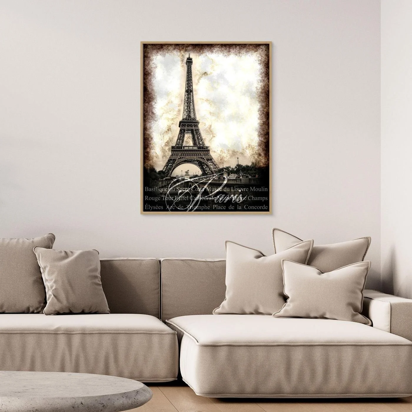 Vintage fine art print of Paris featuring the Eiffel Tower with a textured sepia background and elegant typography of French landmarks, framed and ready to hang. Over grey couch