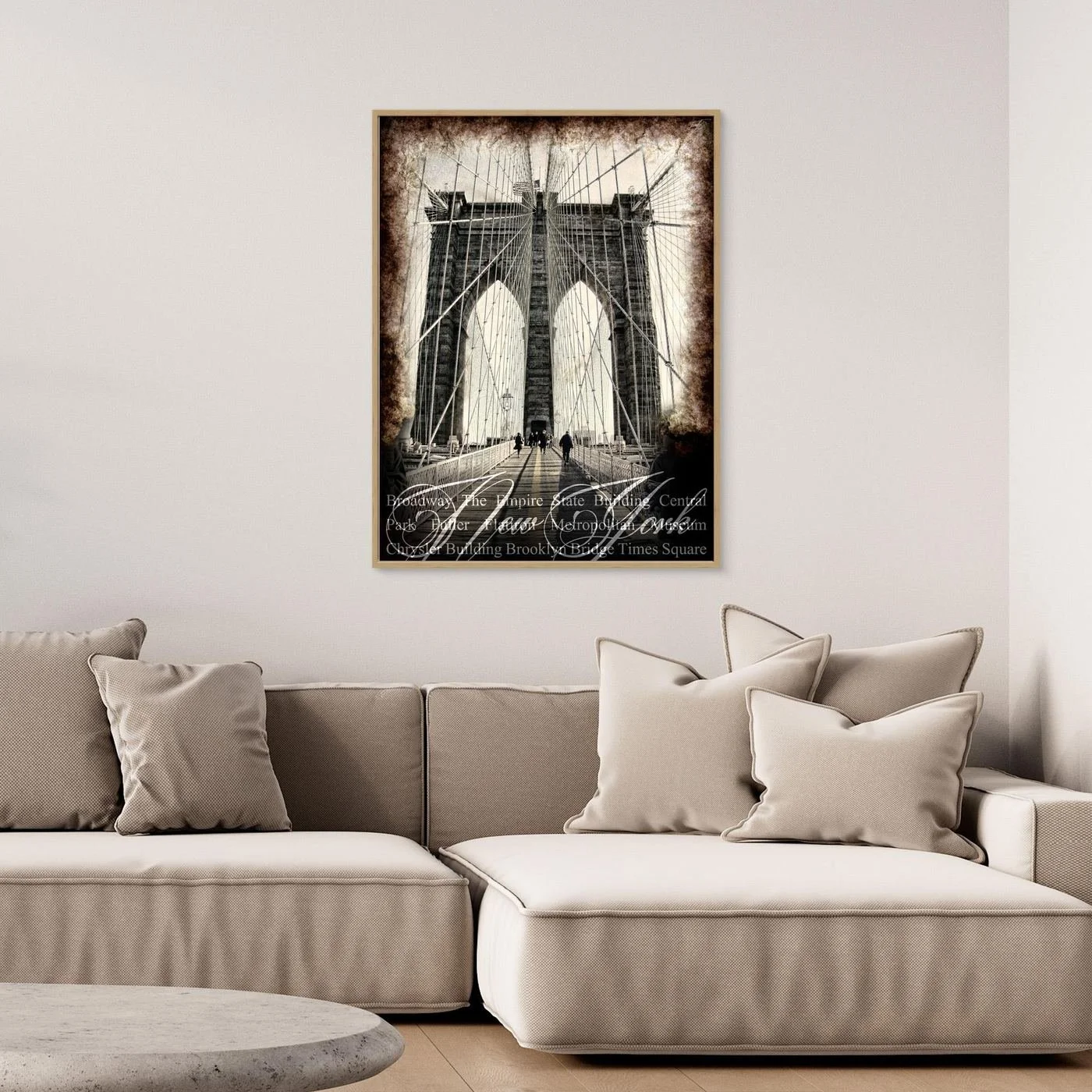 Vintage fine art print of New York City of Brooklyn Bridge with a textured sepia background and elegant typography of NYC landmarks, framed and ready to hang. Over grey couch