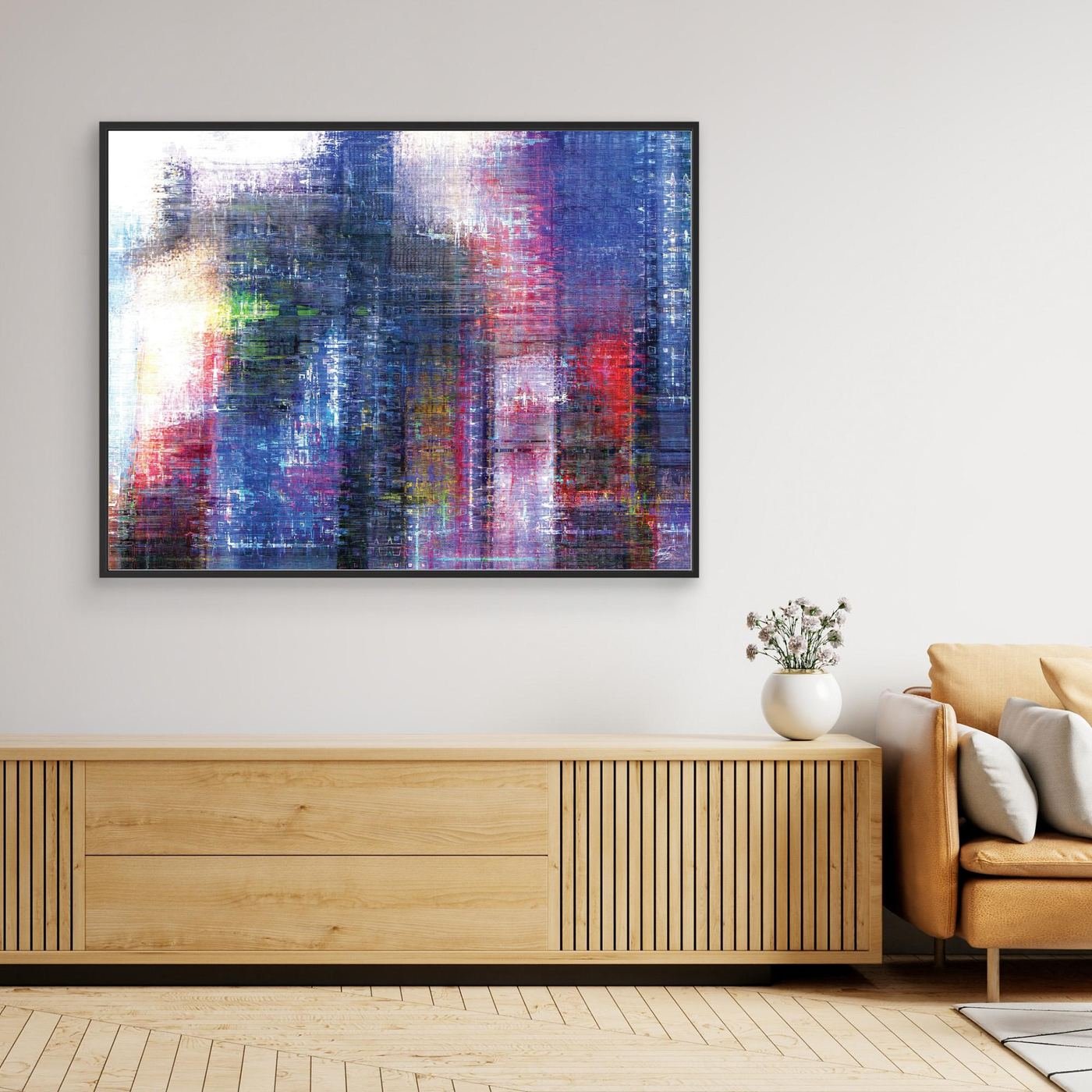 Abstract fine art print evoking a textured city skyline with vertical lines in deep blue, purple, and red tones, framed and ready to hang. Over wooden console