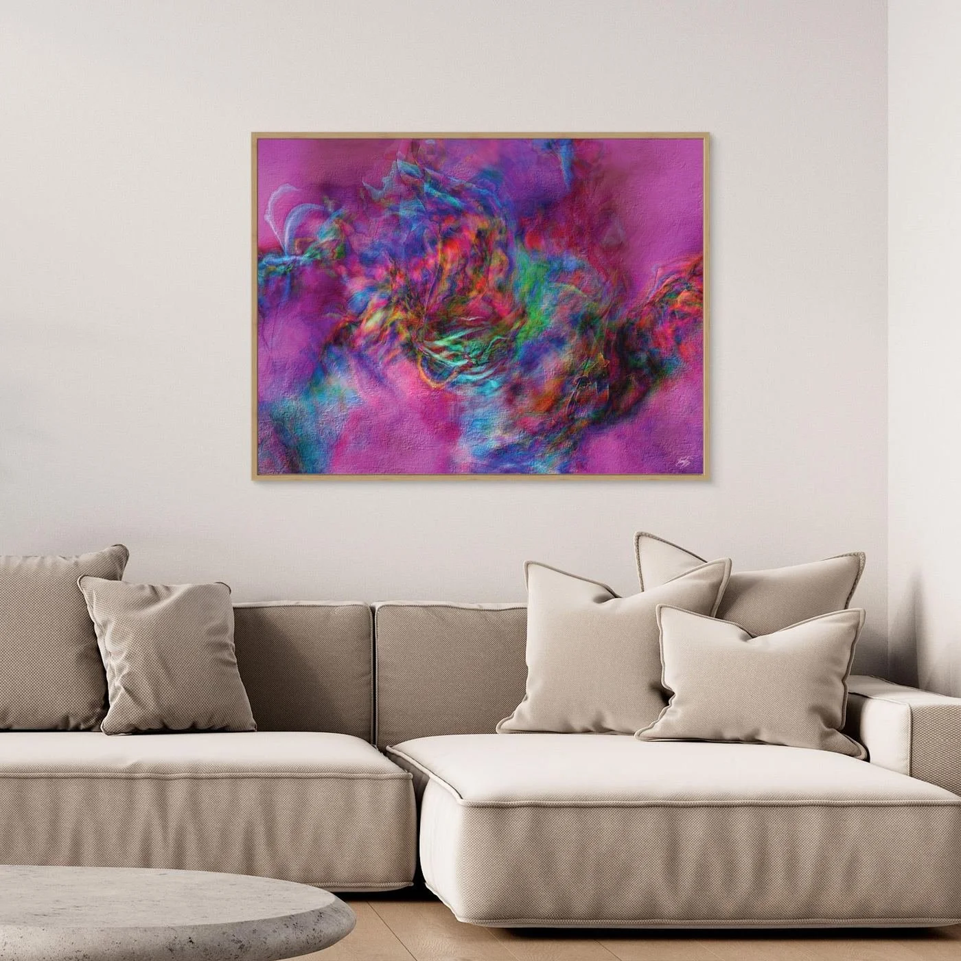 Abstract fine art print with heavy plaster-like texture featuring a vibrant magenta and pink background with a colorful swirling center, framed and ready to hang. Over grey couch