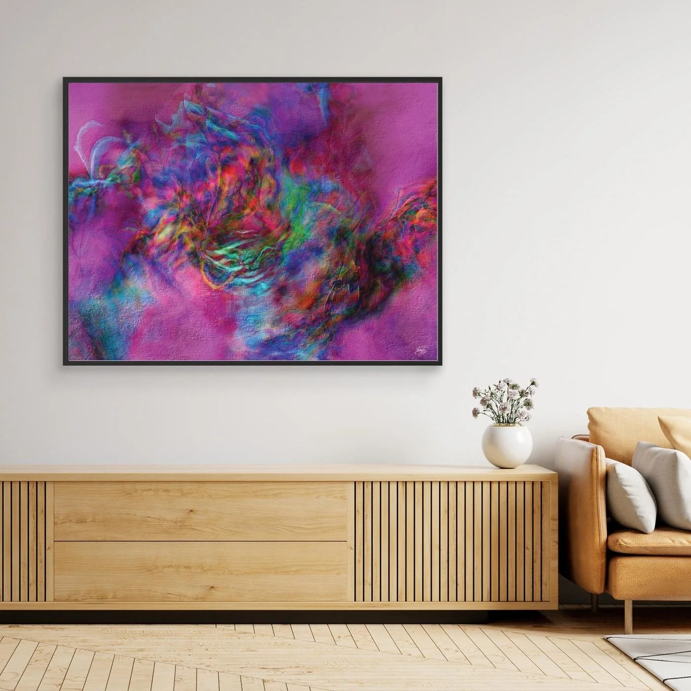 Abstract fine art print with heavy plaster-like texture featuring a vibrant magenta and pink background with a colorful swirling center, framed and ready to hang. Over wooden console