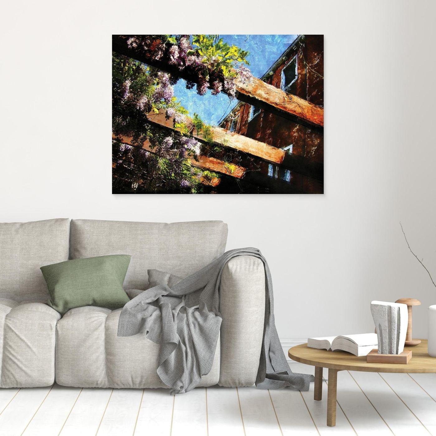 Impressionist fine art print showcasing purple wisteria flowers climbing over rustic wooden pergola beams against a textured blue sky, framed and ready to hang. In living room