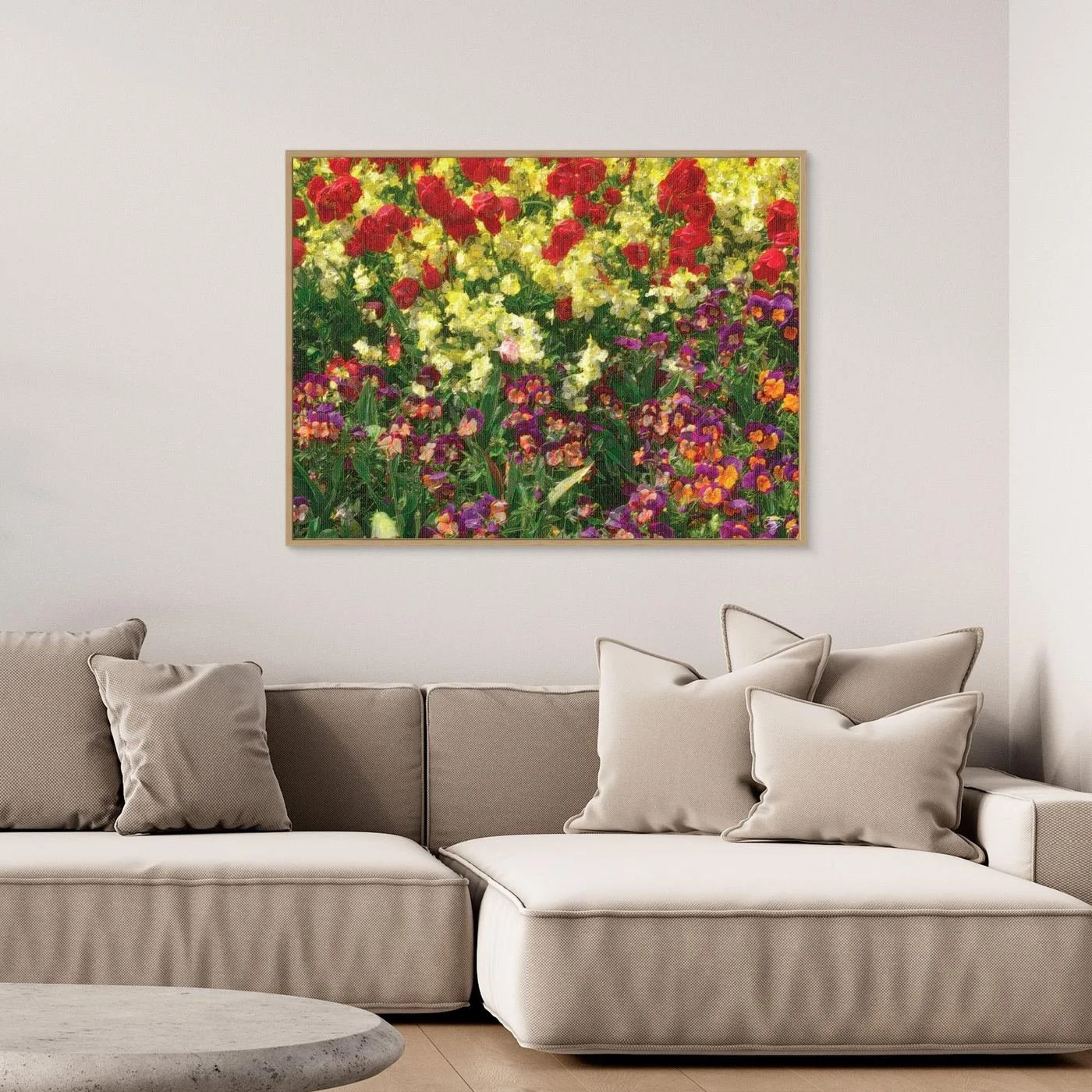 Impressionist art print showcasing a field of spring flowers with oil painting textures, red tulips, yellow blossoms, and purple pansies, framed and ready to hang. Over grey couch