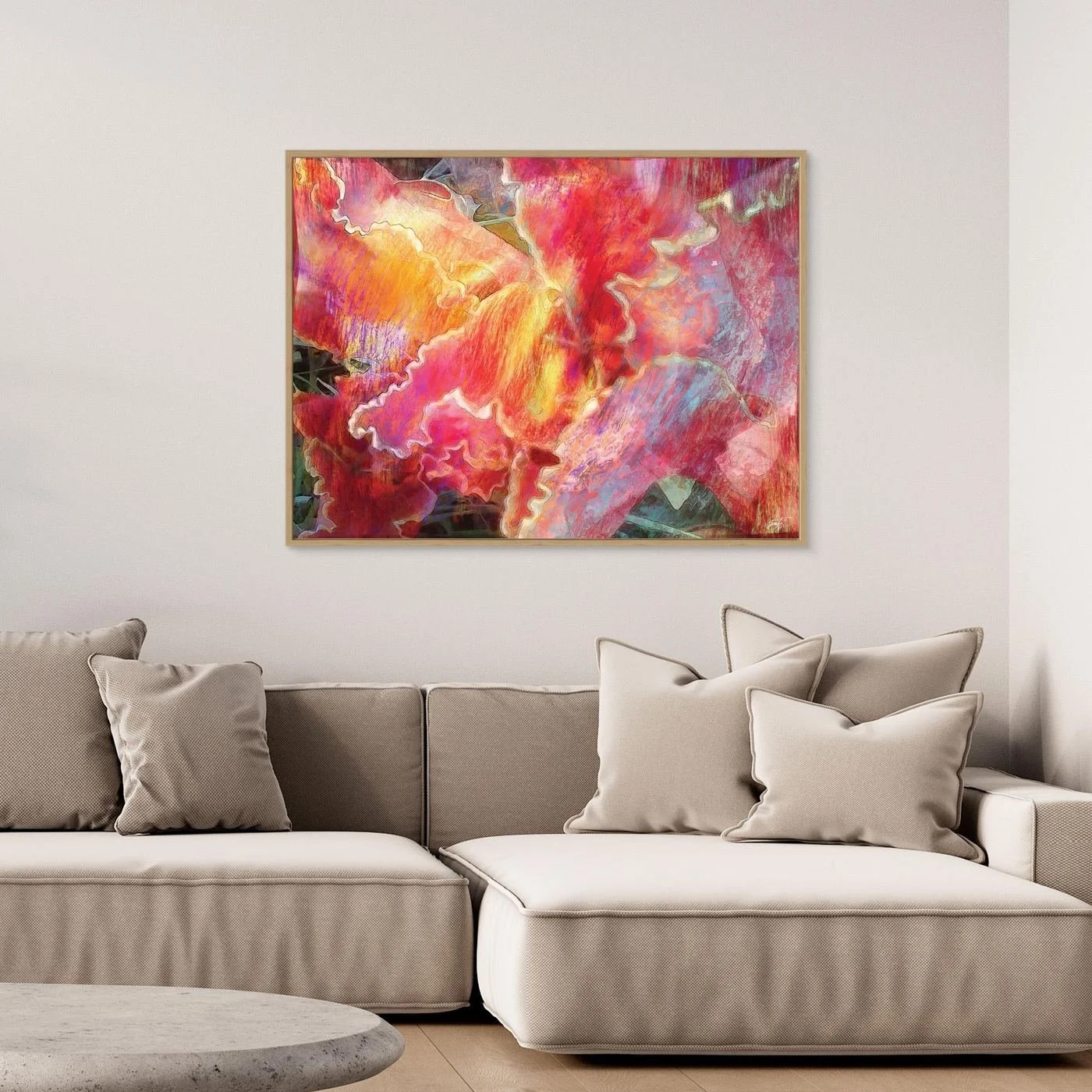Abstract fine art print featuring fluid, textured wavy edges in vibrant coral pink, orange, and golden yellow with subtle hints of light blue, framed and ready to hang. Over grey couch