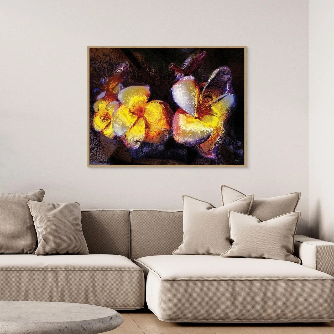 Abstract fine art print featuring textured glowing frangipani plumeria flowers in yellow and orange tones against a dark, moody background, framed and ready to hang. Over grey couch