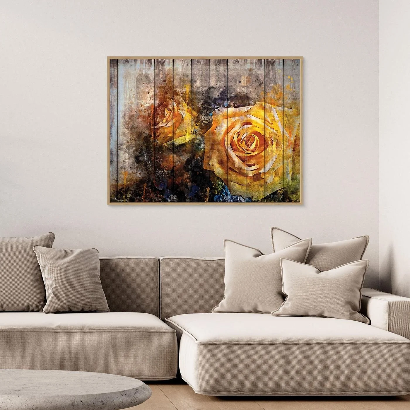 Vintage-style fine art print featuring an abstract yellow rose in watercolor splatters overlaid on a rustic wooden plank texture background, framed and ready to hang. Over grey couch