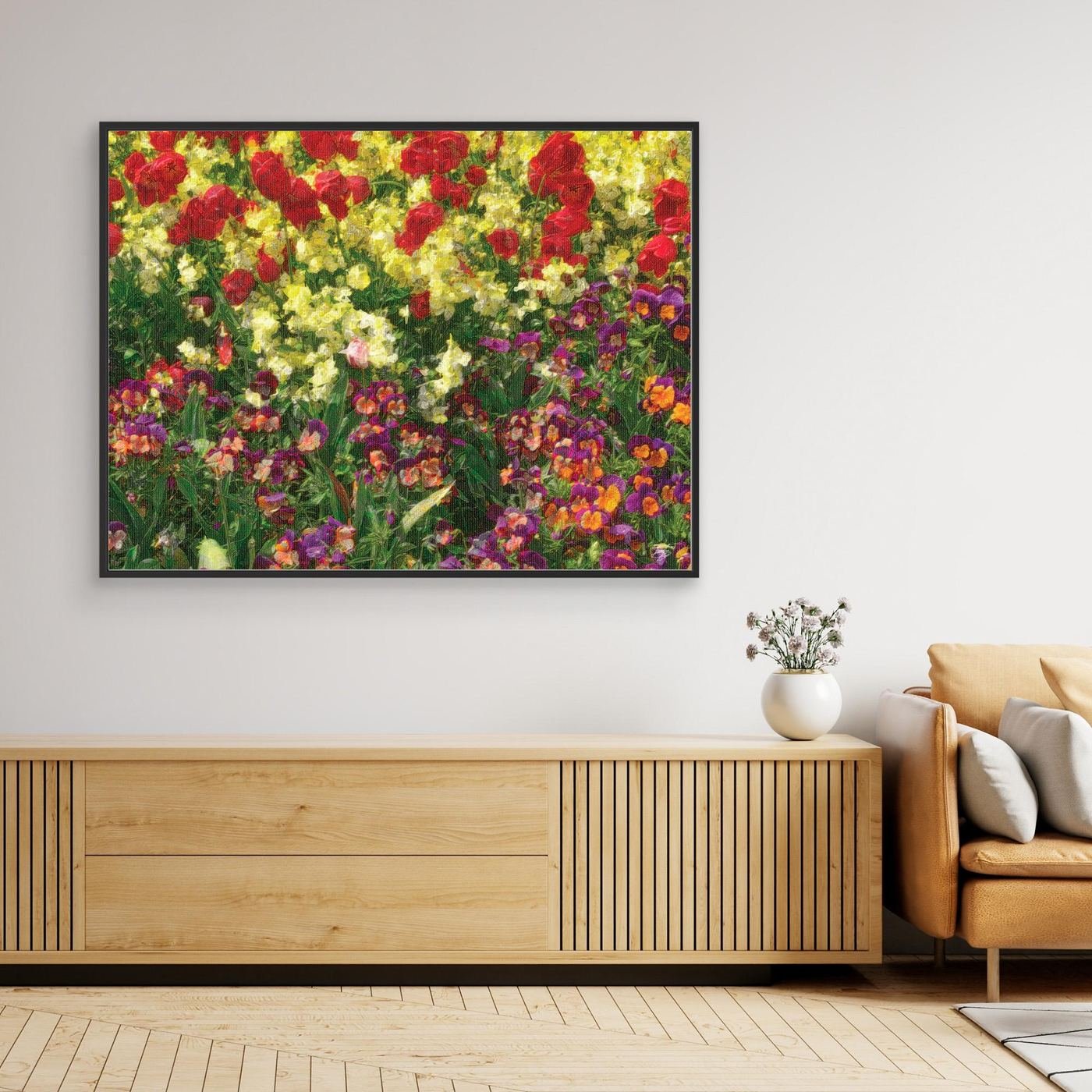 Impressionist art print showcasing a field of spring flowers with oil painting textures, red tulips, yellow blossoms, and purple pansies, framed and ready to hang. Over wooden console