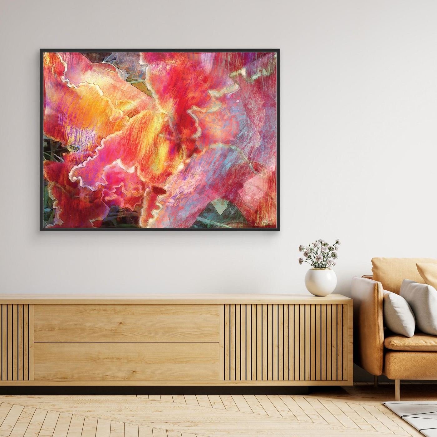 Abstract fine art print featuring fluid, textured wavy edges in vibrant coral pink, orange, and golden yellow with subtle hints of light blue, framed and ready to hang. Over wooden console