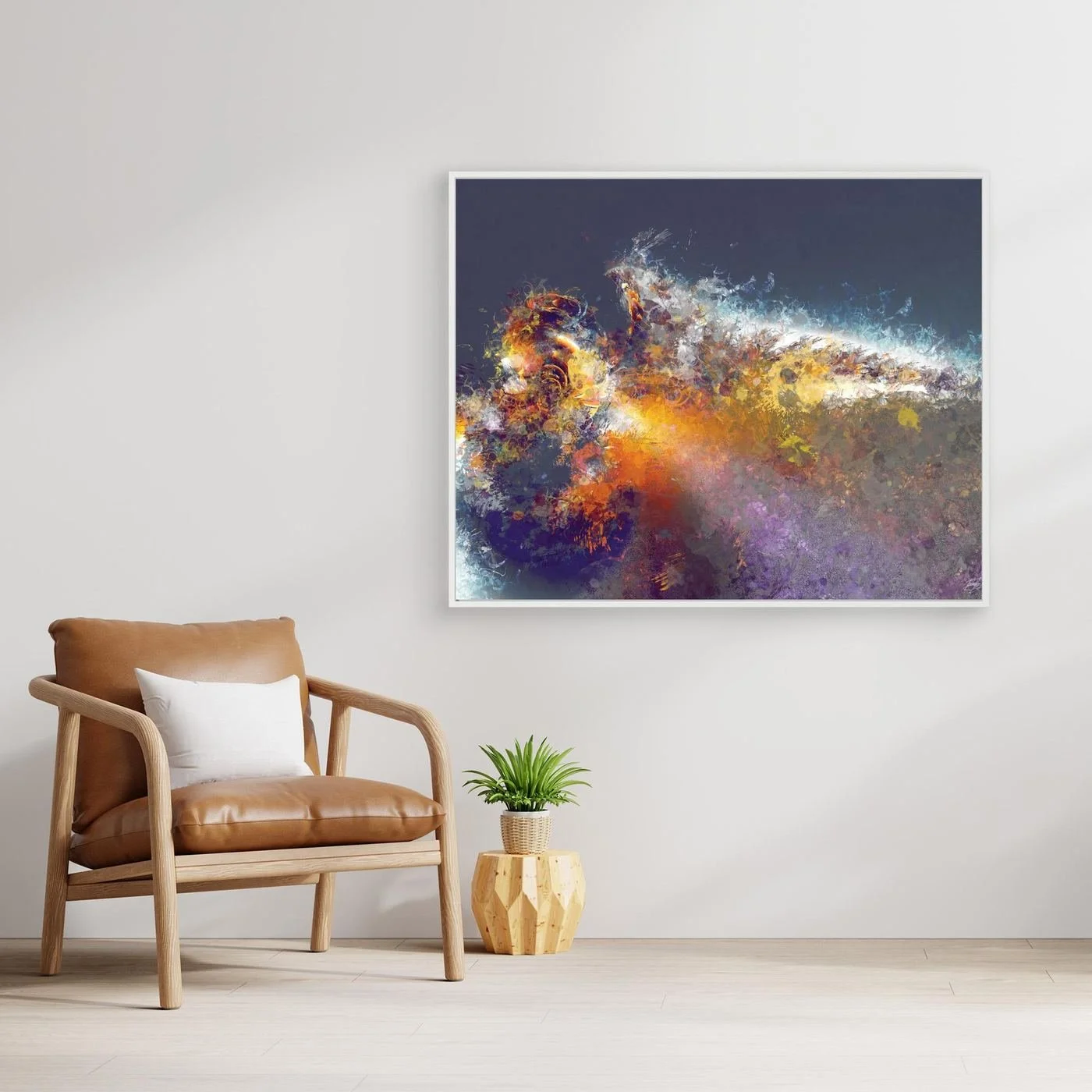 Dynamic abstract fine art print featuring explosive textured splatters in gold, orange, and white tones against a dark grey background, framed and ready to hang. With chair