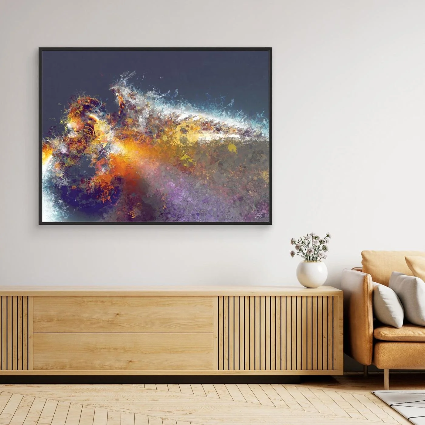 Dynamic abstract fine art print featuring explosive textured splatters in gold, orange, and white tones against a dark grey background, framed and ready to hang. Over wooden console